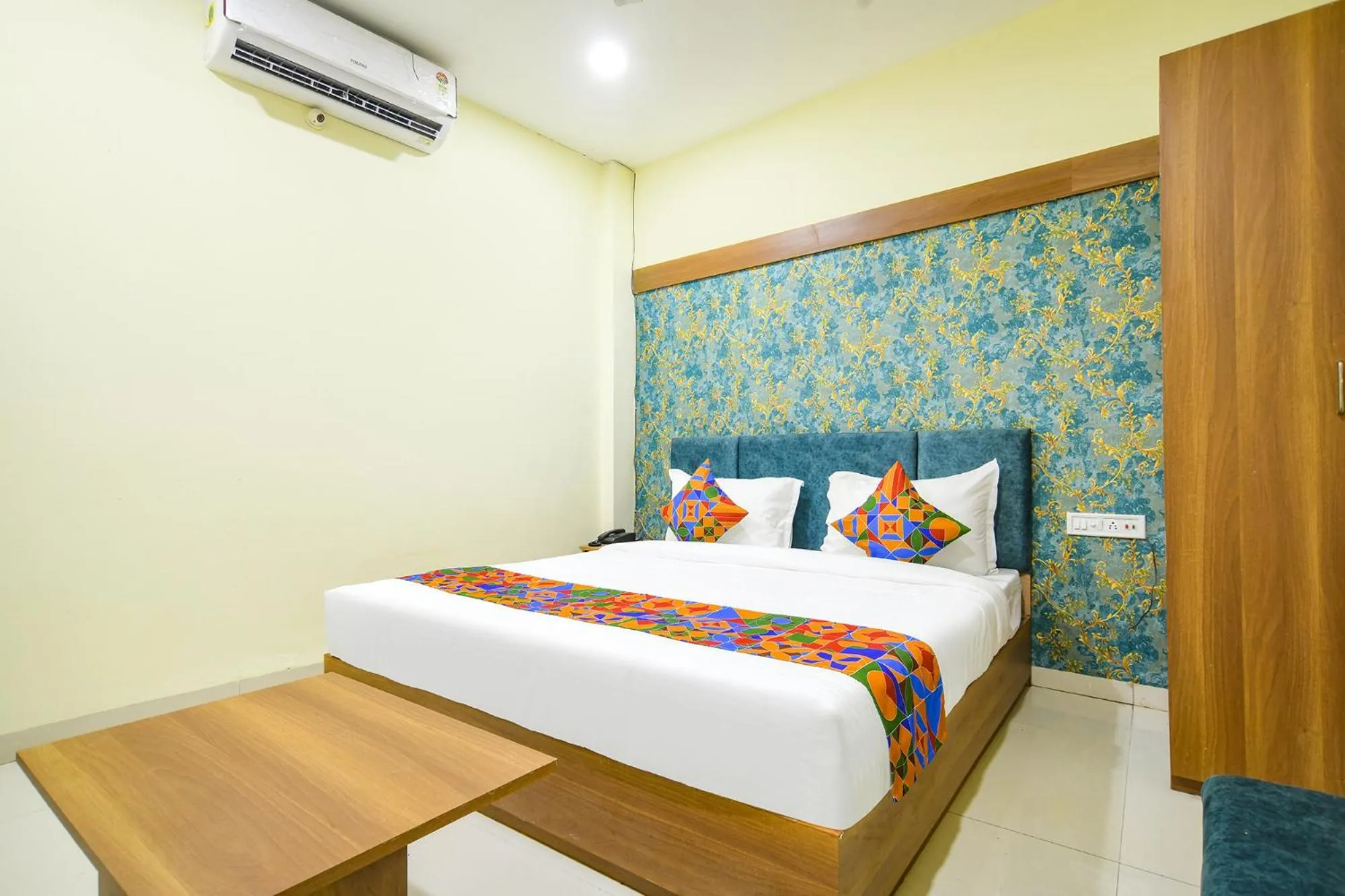 Bed in FabHotel Grand Giriraj
