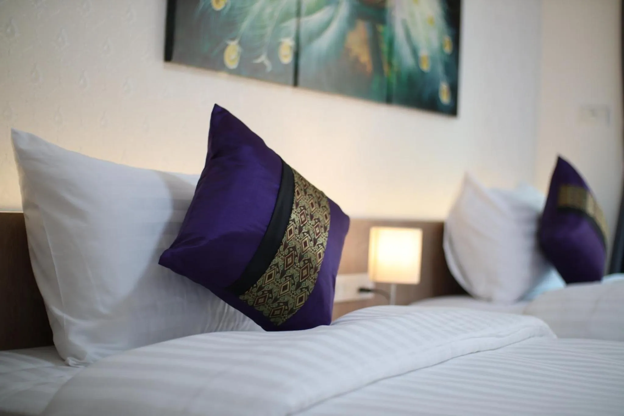 Bed in Peacock De Pai Hotel