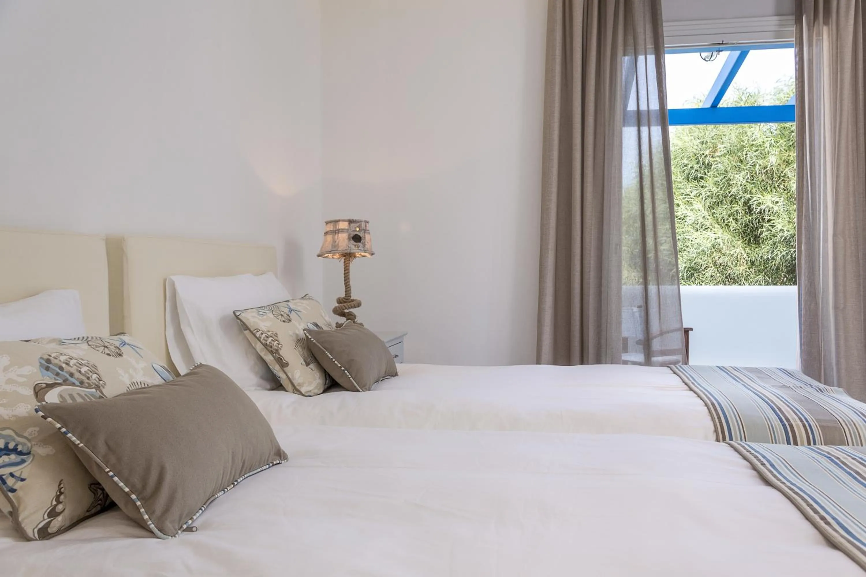 Bed in Poseidon of Paros Hotel & Spa