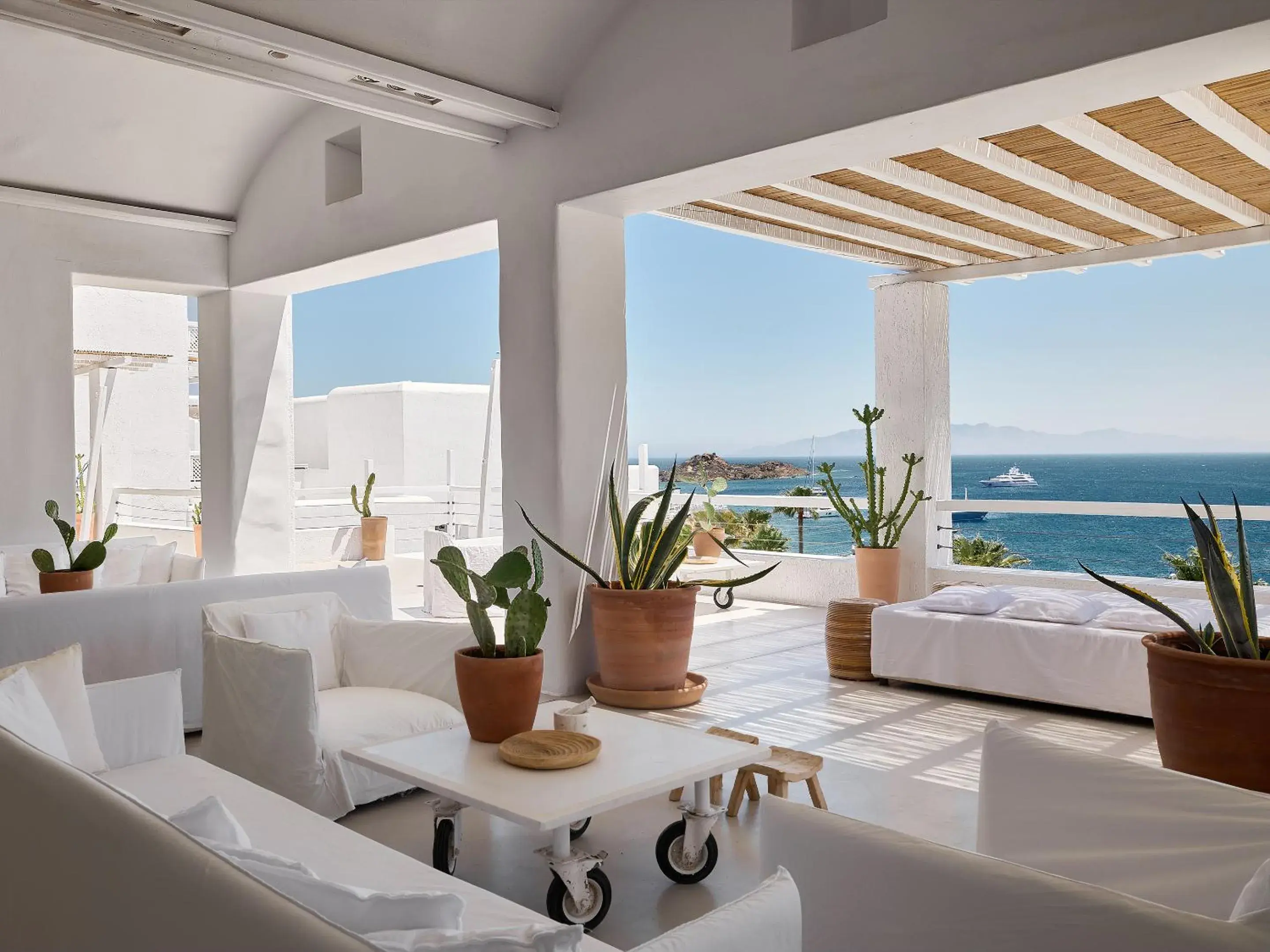Patio, Bed in Mykonos Blu, A Grecotel Resort to Live Patio, Bed in Mykonos Blu, A Grecotel Resort to Live