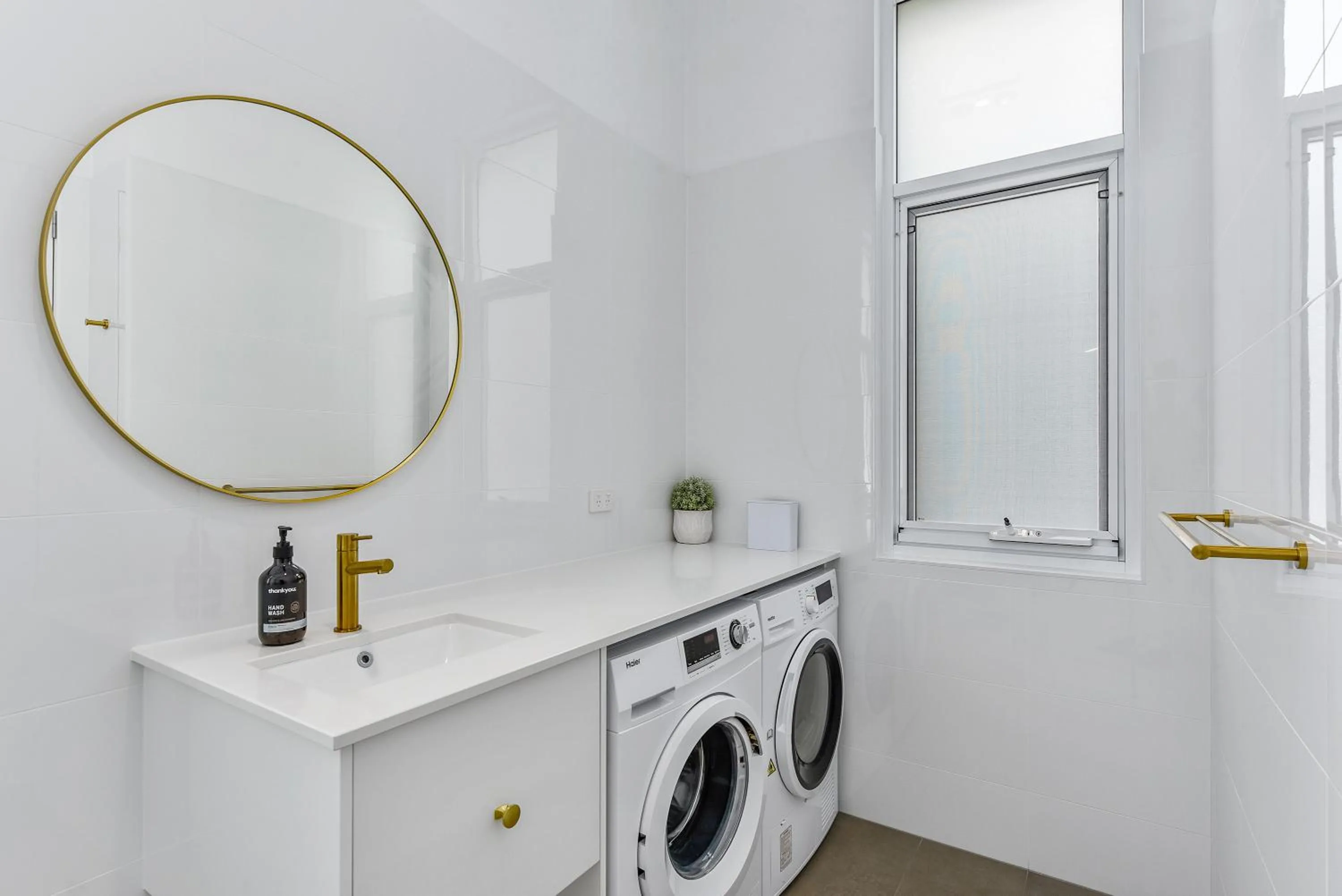washing machine in Aloha Central Platinum Apartments