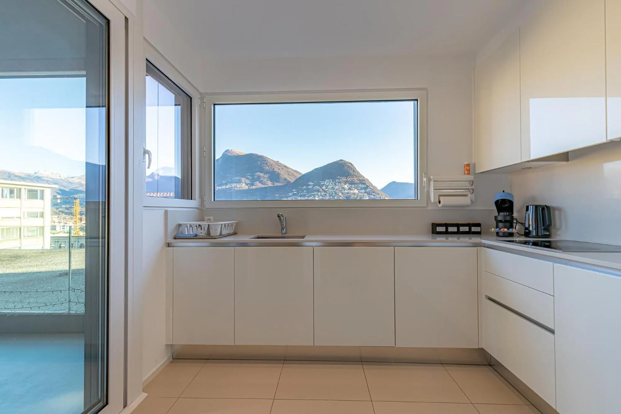 Kitchen or kitchenette in IMPERIAL of LUGANO 3 with a lake view behind the station and 10 min from the lake of Lugano
