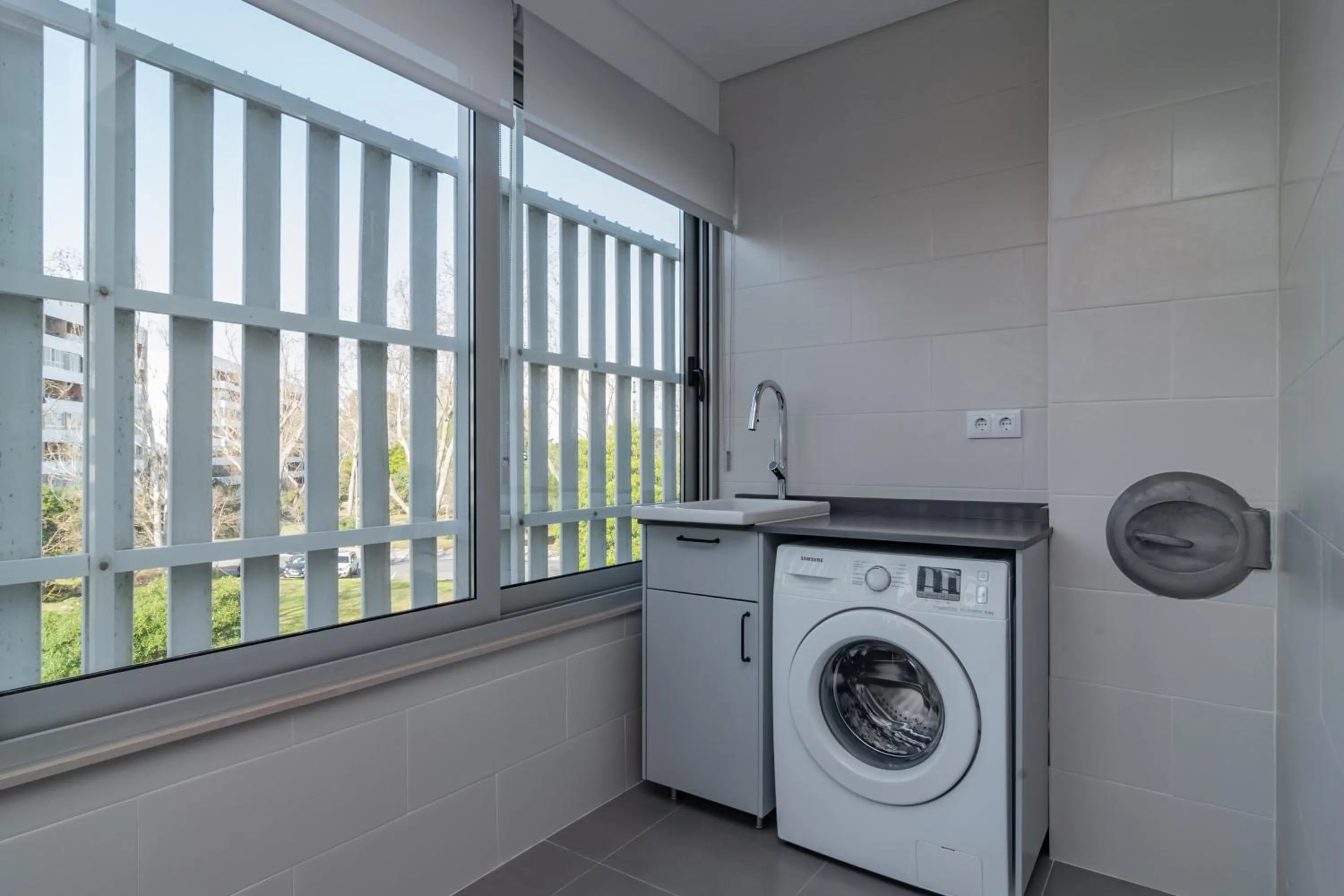washing machine in Coastal Charm by LovelyStay