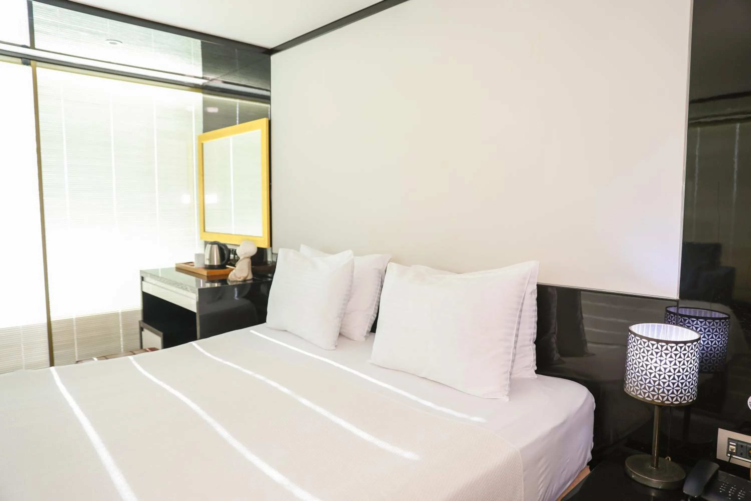 Bed in The Hera Platinum Hotel