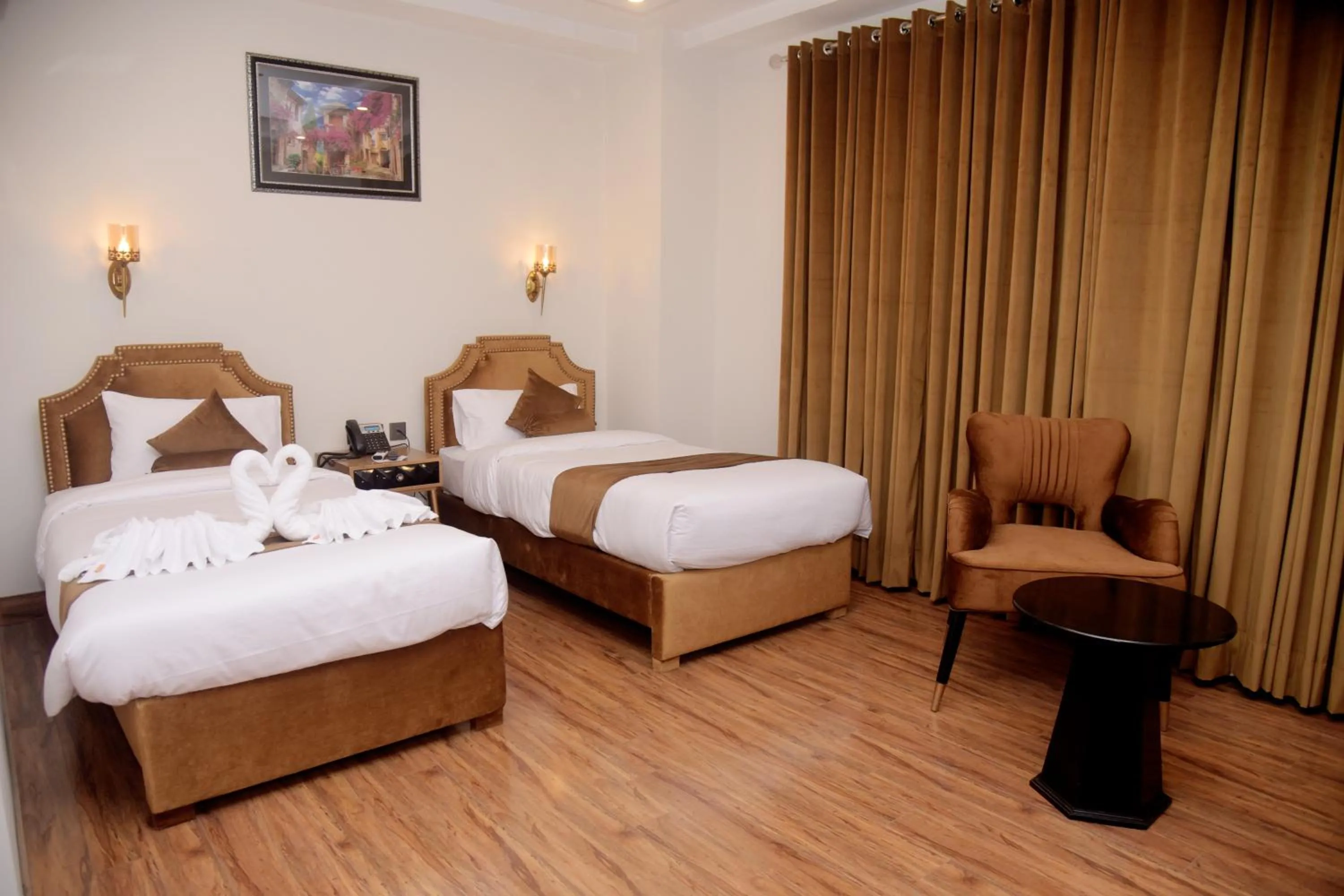 Bed in The Rich Hotel & Apartments