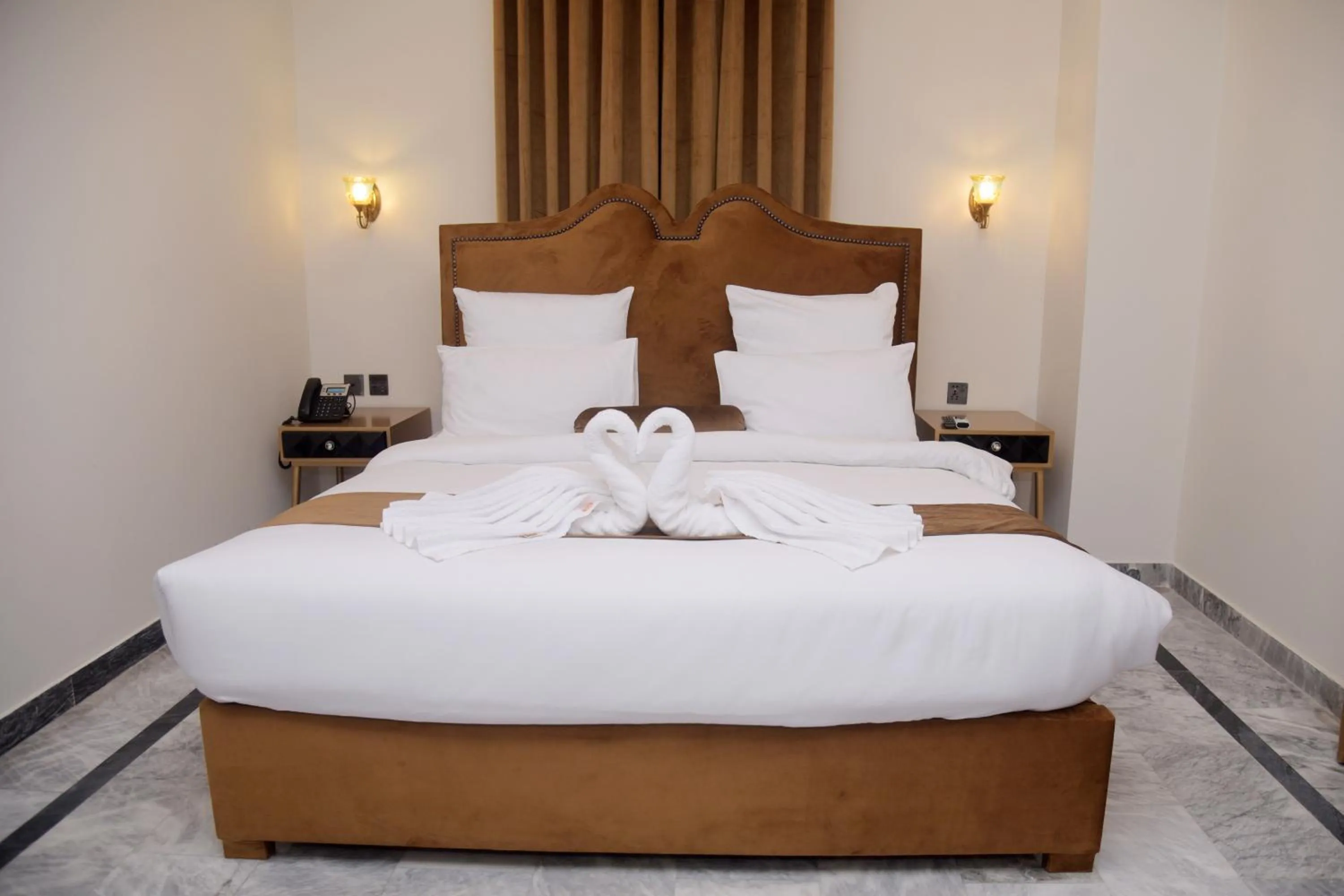 Bed in The Rich Hotel & Apartments