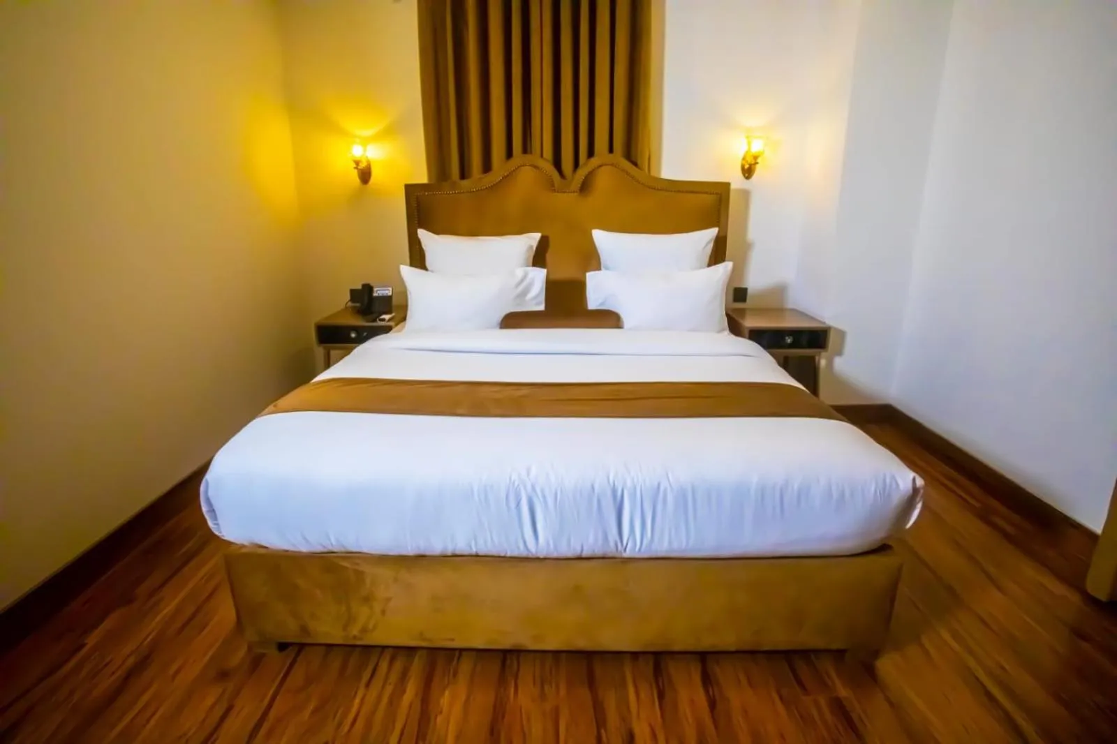 Bed in The Rich Hotel & Apartments