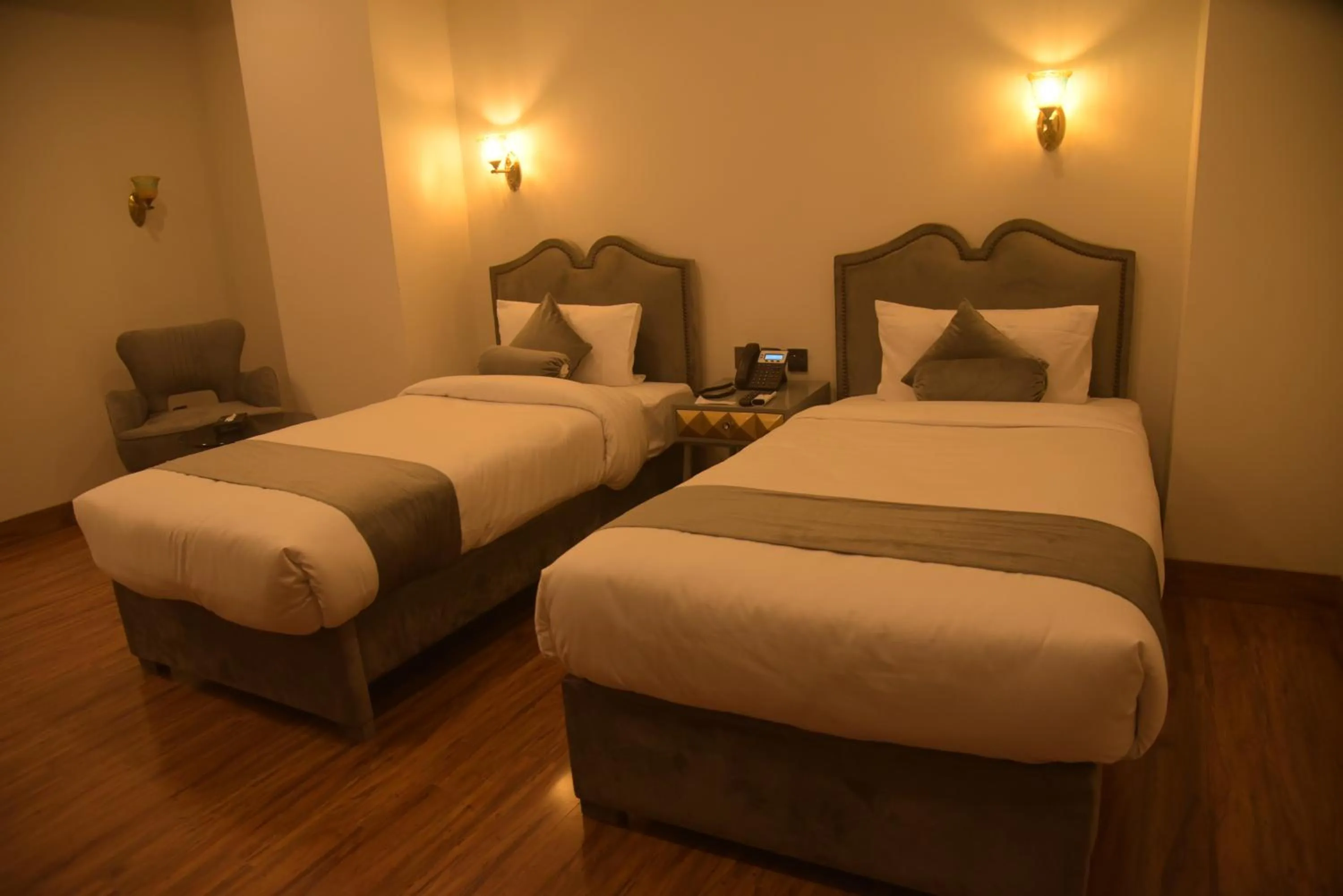 Bed in The Rich Hotel & Apartments