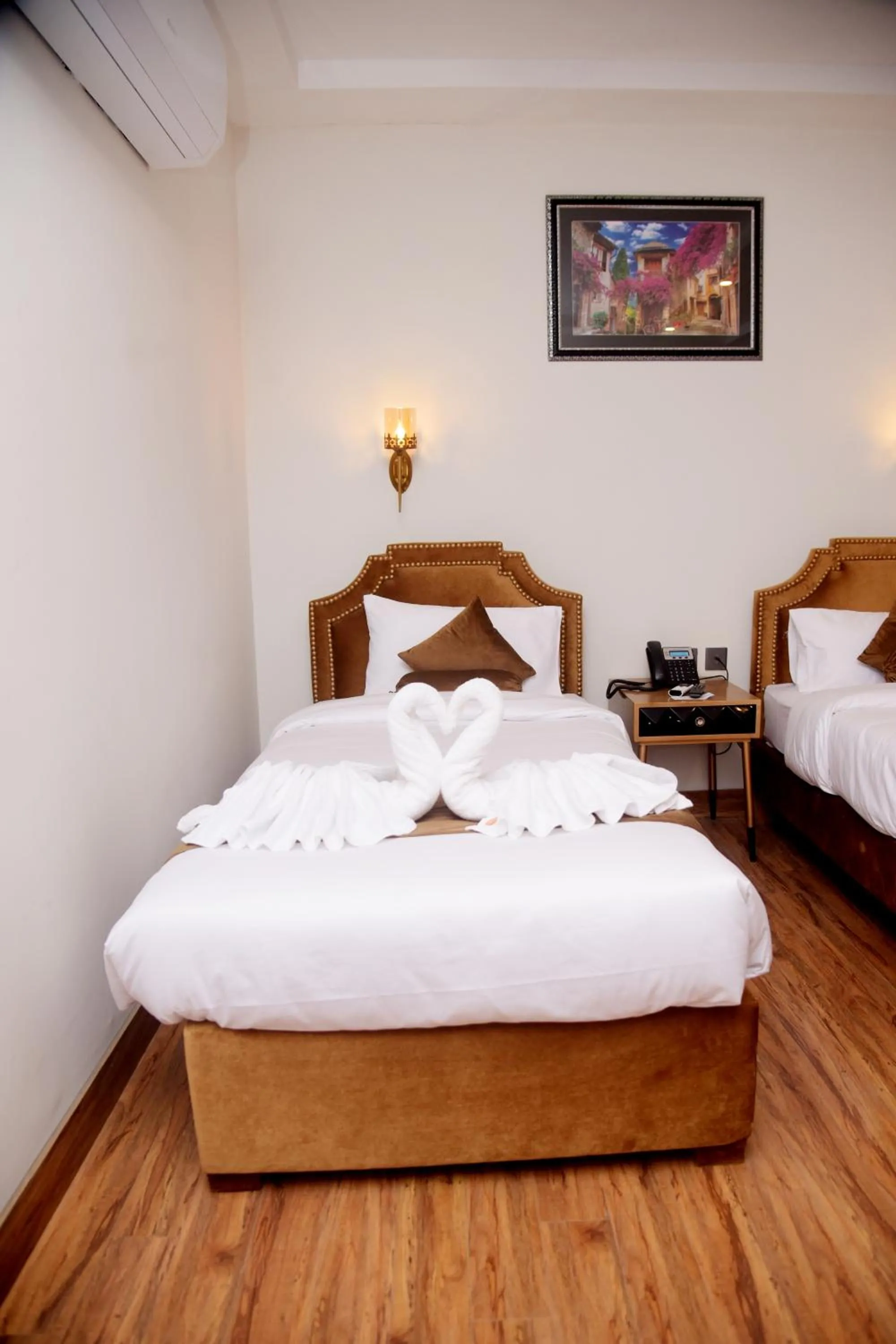 Bed in The Rich Hotel & Apartments