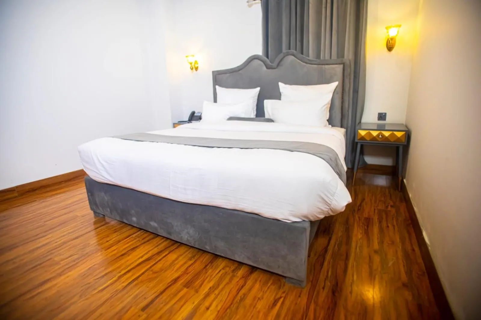 Bed in The Rich Hotel & Apartments