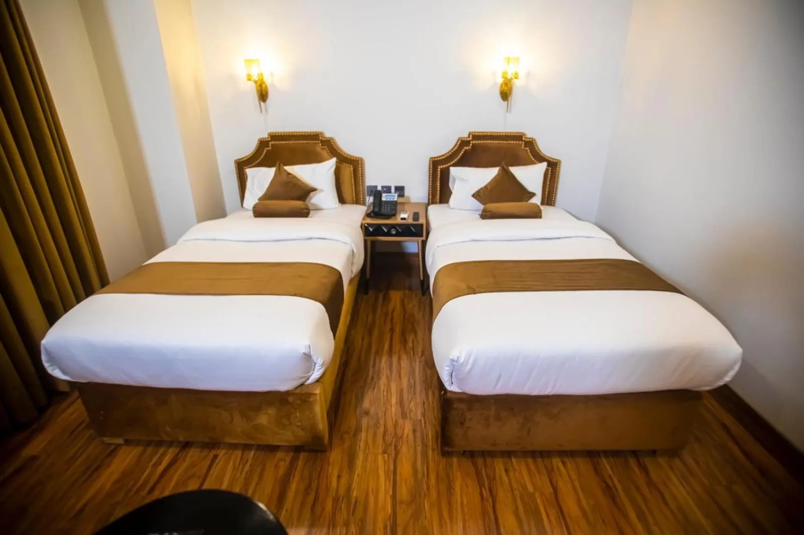 Bed in The Rich Hotel & Apartments