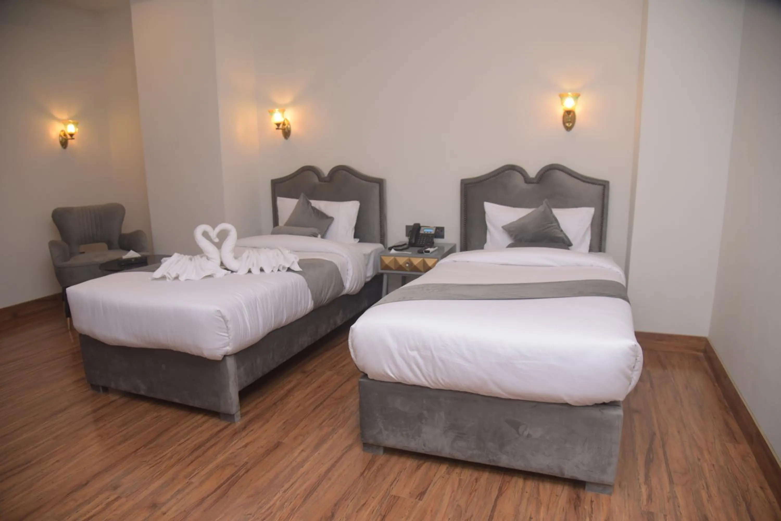 Bed in The Rich Hotel & Apartments