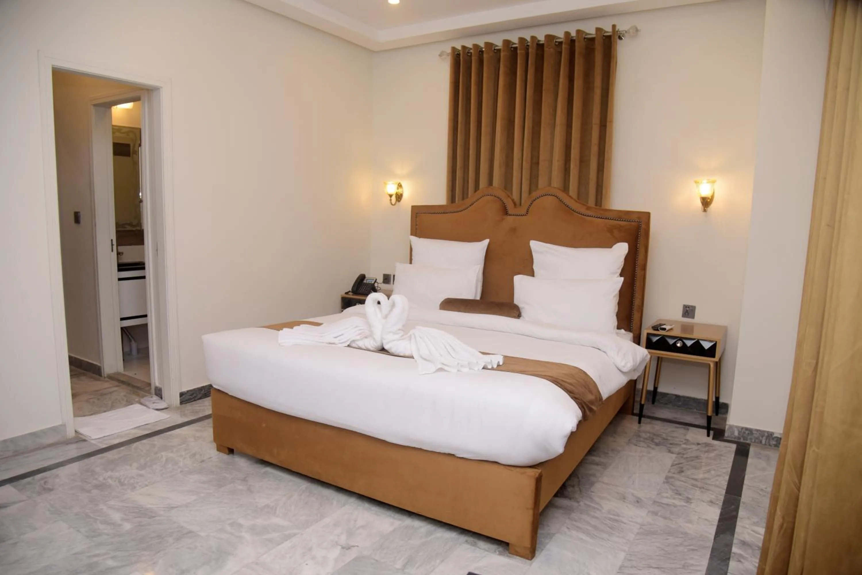 Bed in The Rich Hotel & Apartments