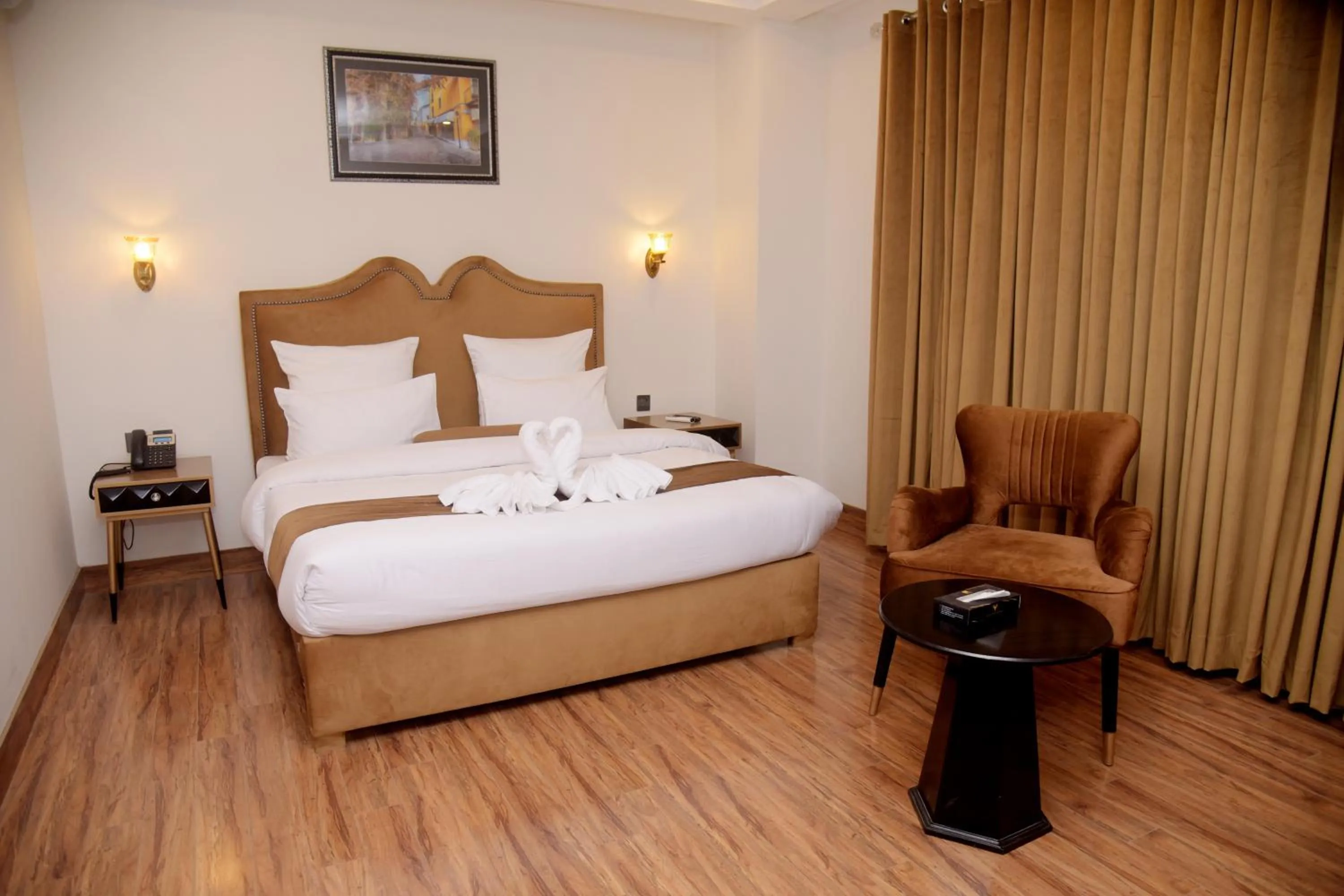 Bed in The Rich Hotel & Apartments