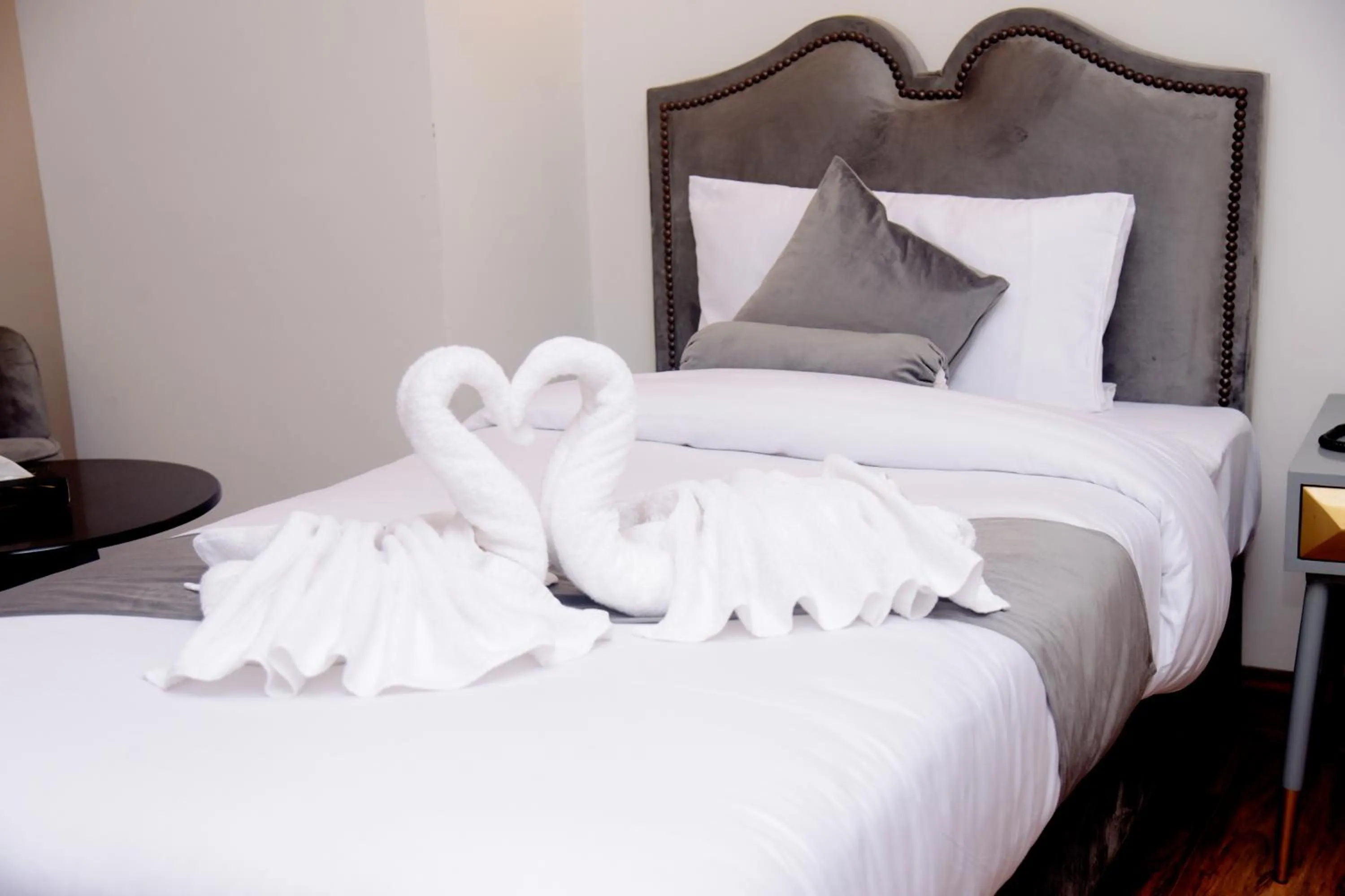 Bed in The Rich Hotel & Apartments