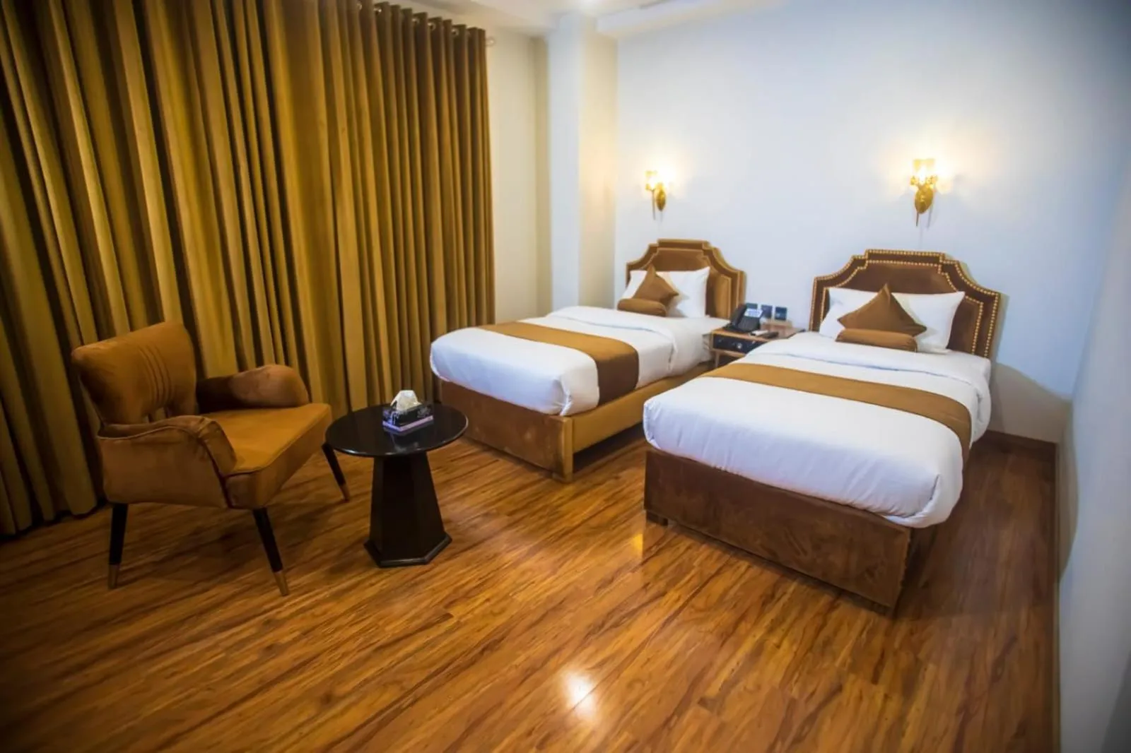 Bed in The Rich Hotel & Apartments