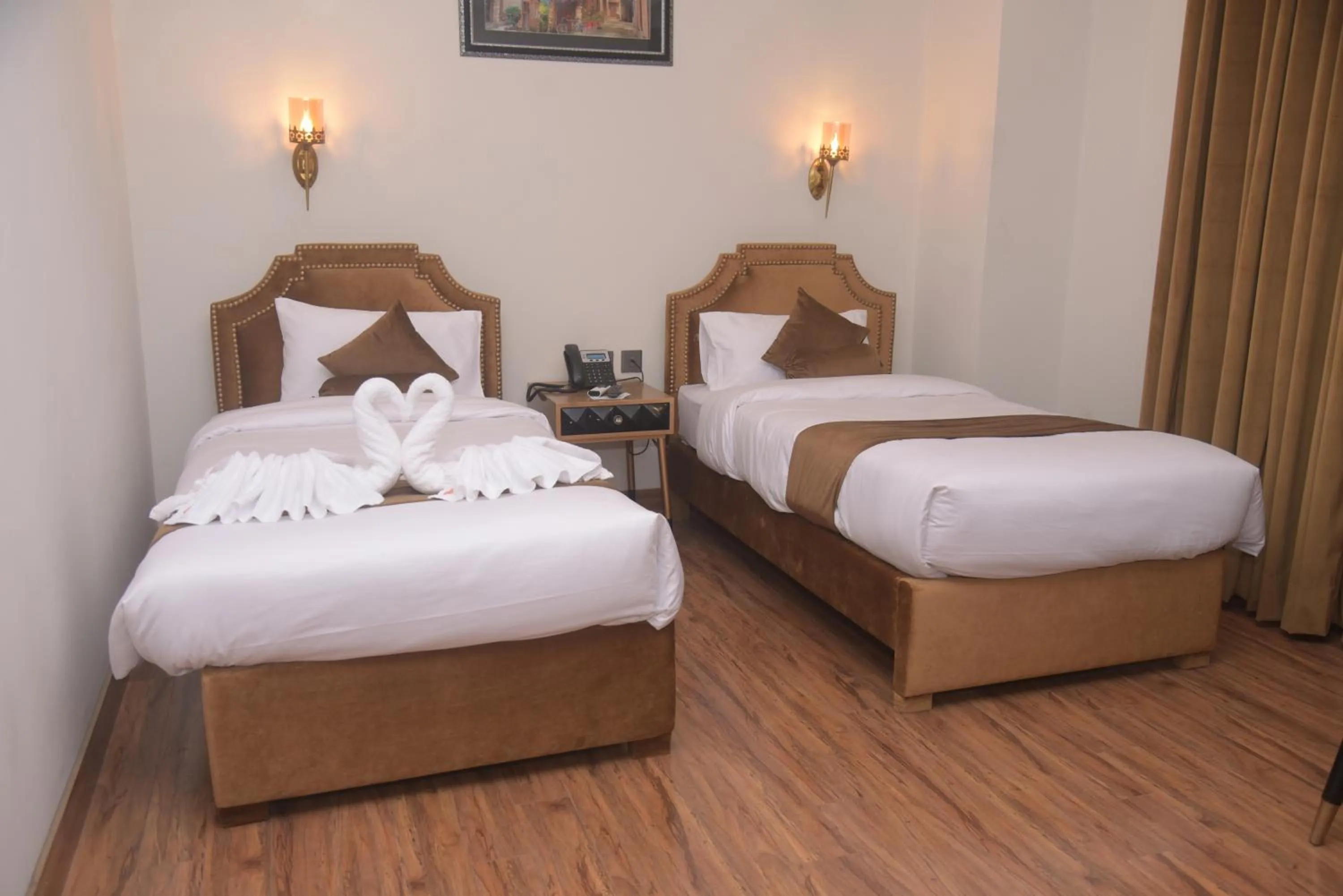 Bed in The Rich Hotel & Apartments