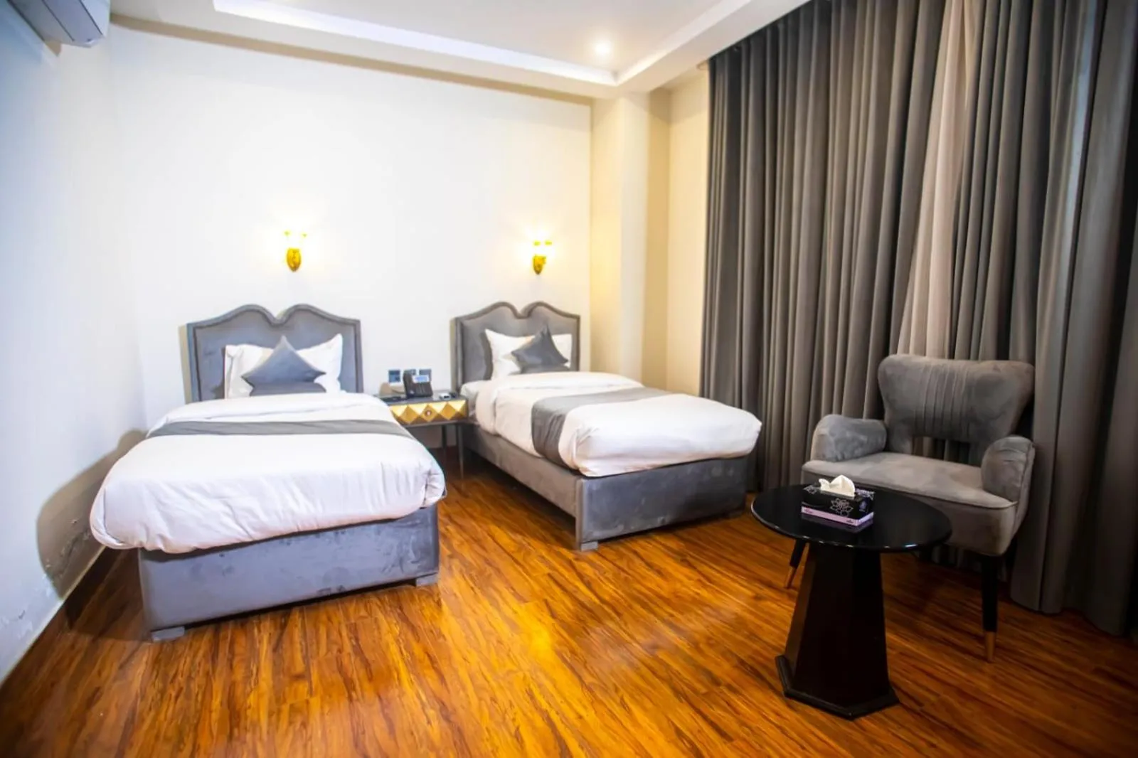 Bed in The Rich Hotel & Apartments