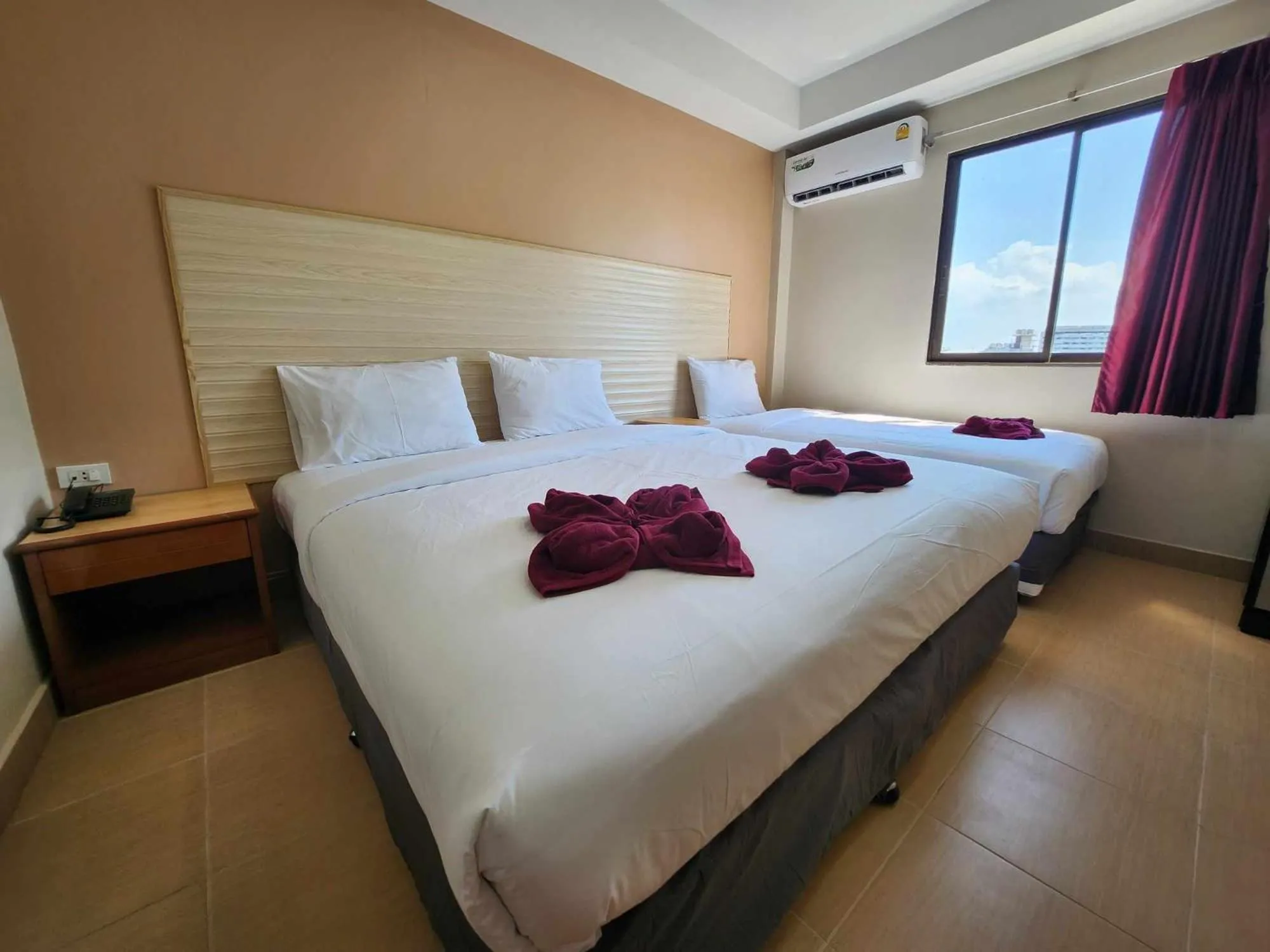 Bed in White Rose​ Hotel​ II​