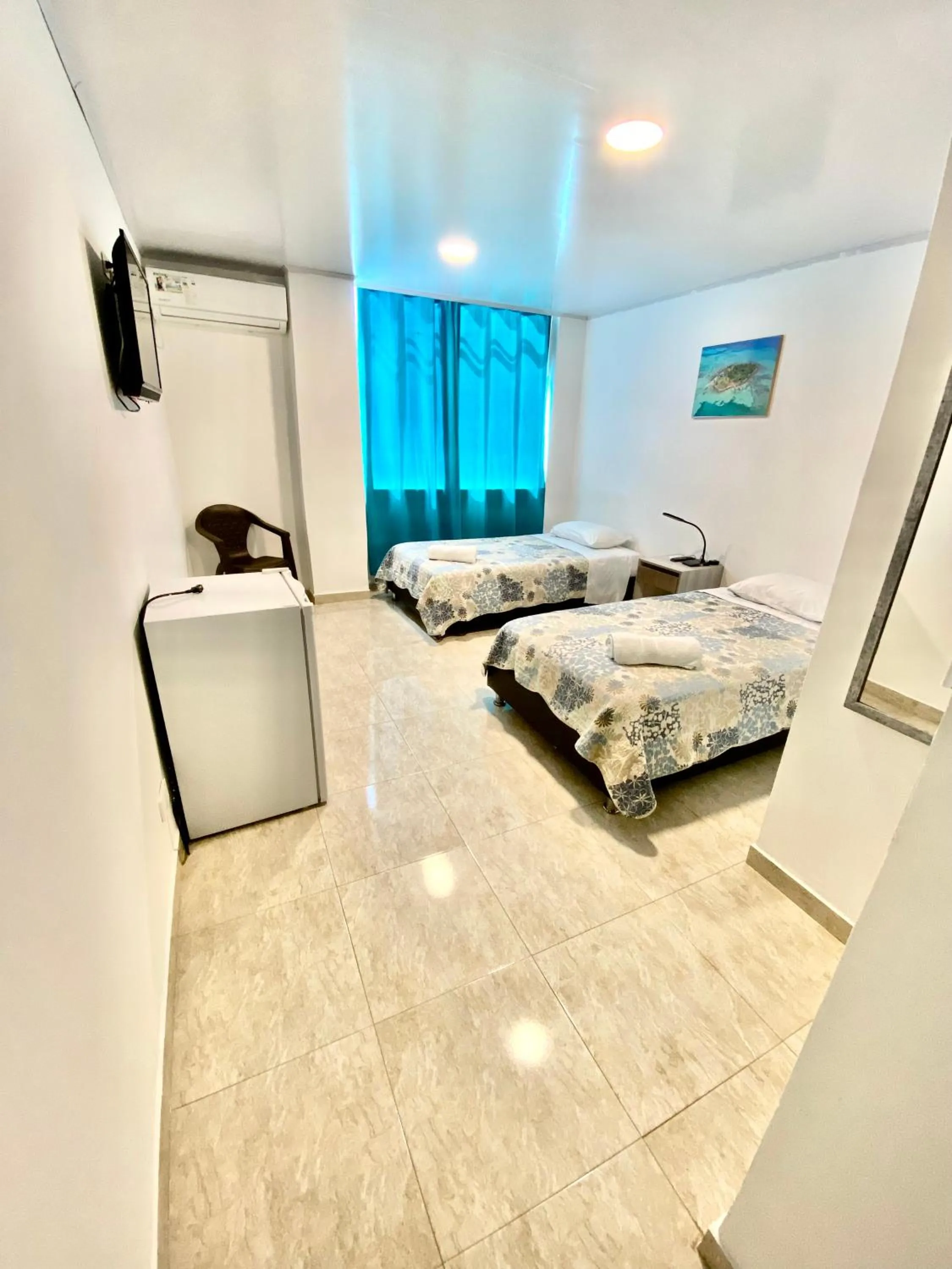 Bed in BLUE ISLAND HOTEL