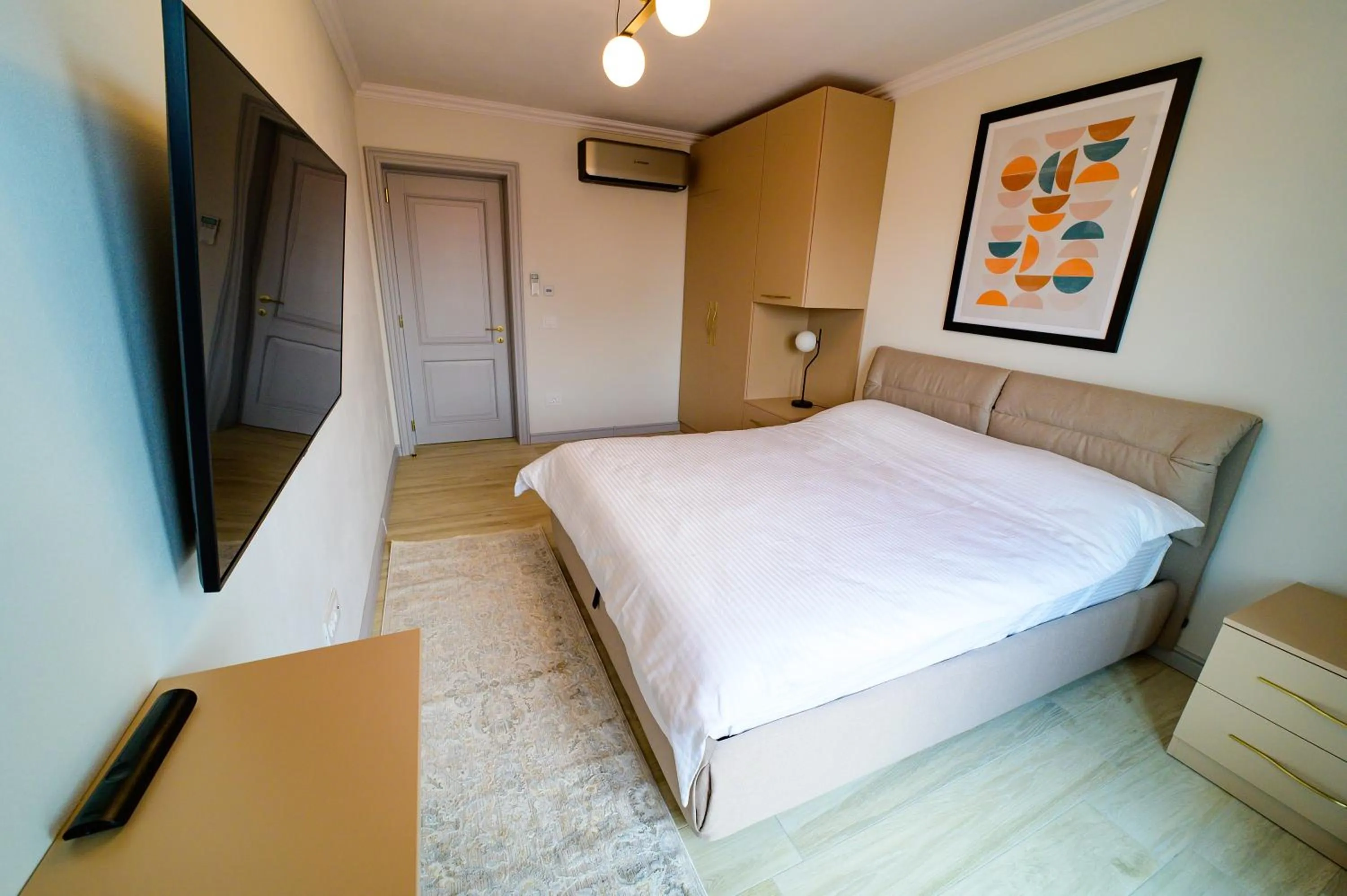 Photo of the whole room, Bed in First Apartments