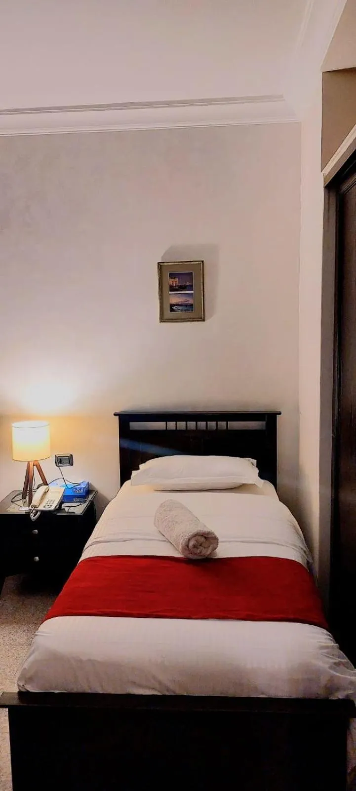 Bed in Tamrah Suites Hotel