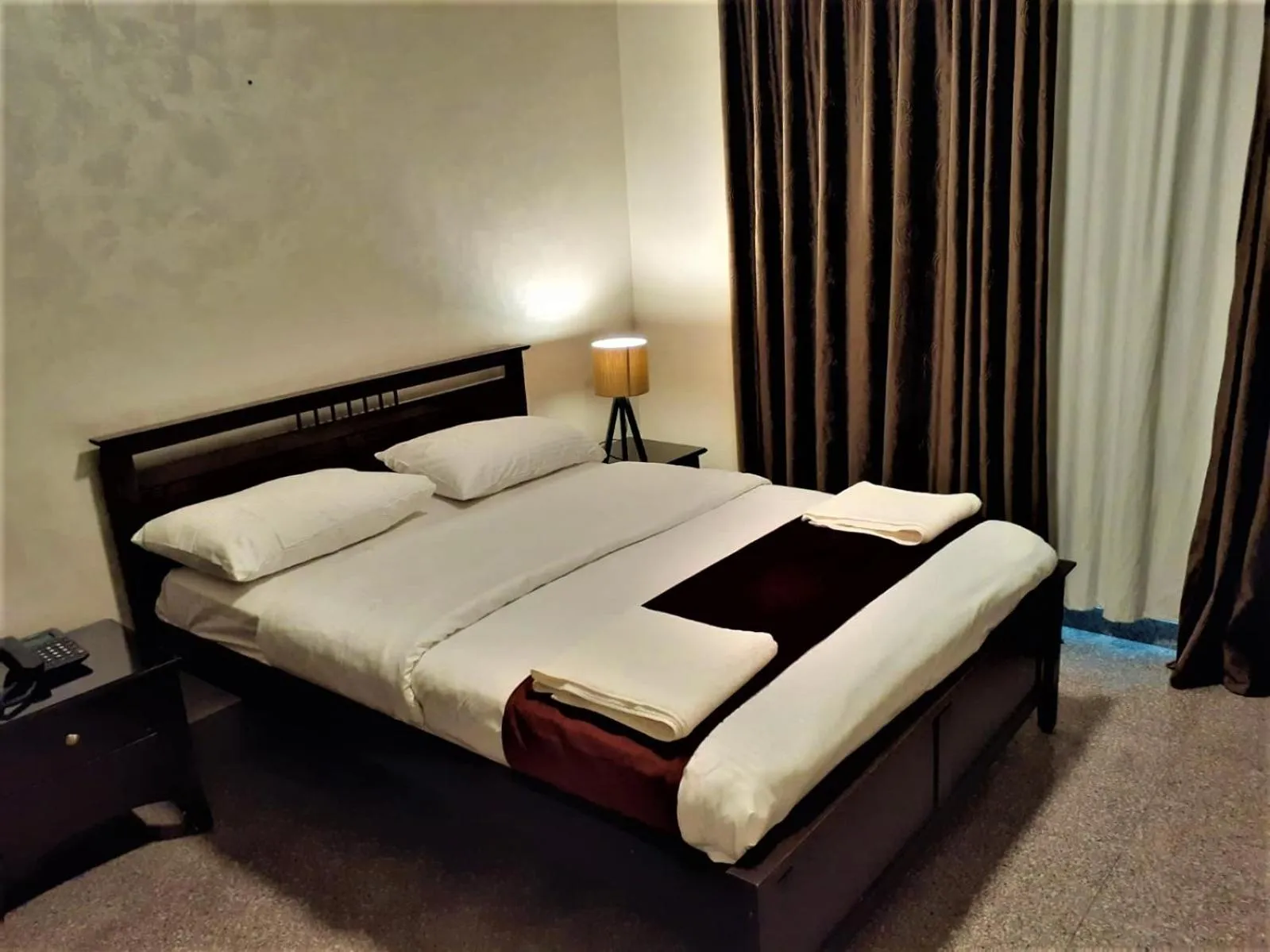 Bed in Tamrah Suites Hotel