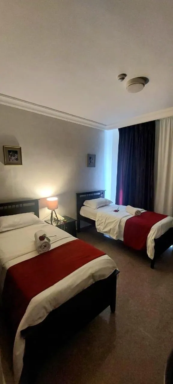 Bed in Tamrah Suites Hotel