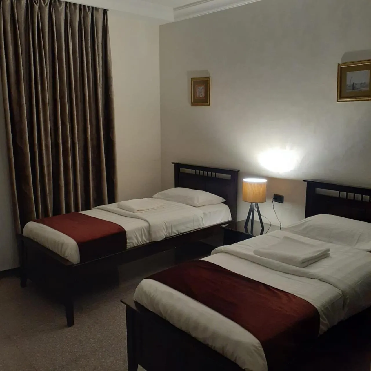 Bed in Tamrah Suites Hotel