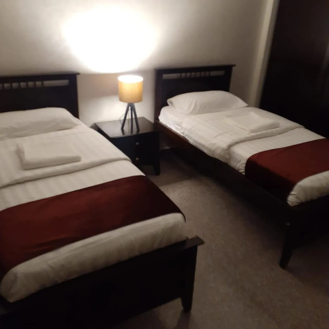 Bed in Tamrah Suites Hotel