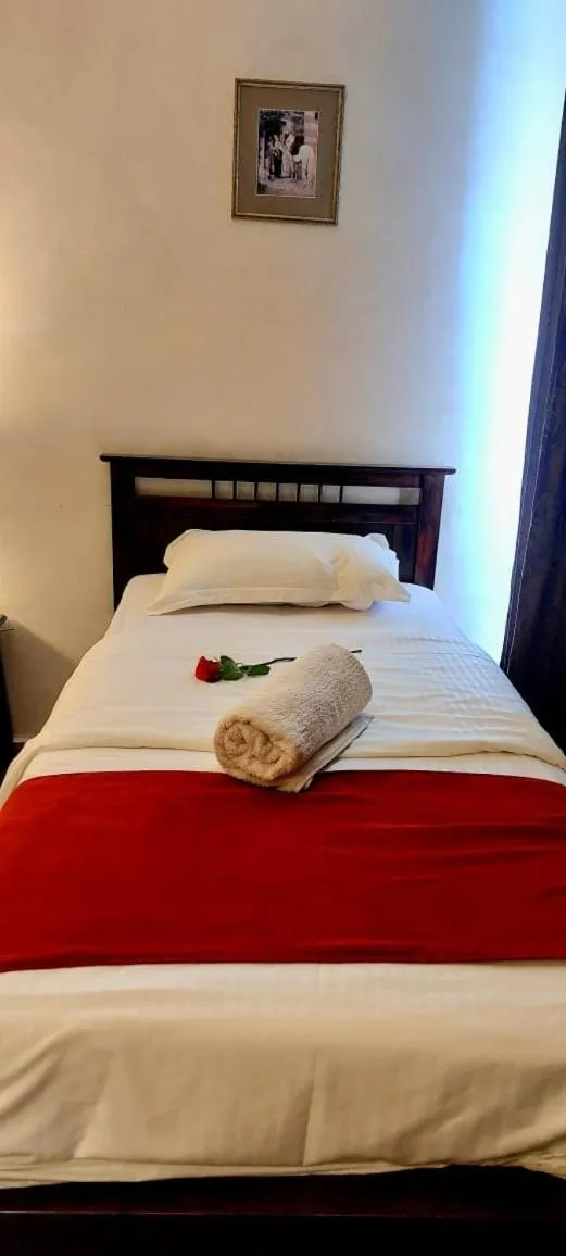 Bed in Tamrah Suites Hotel
