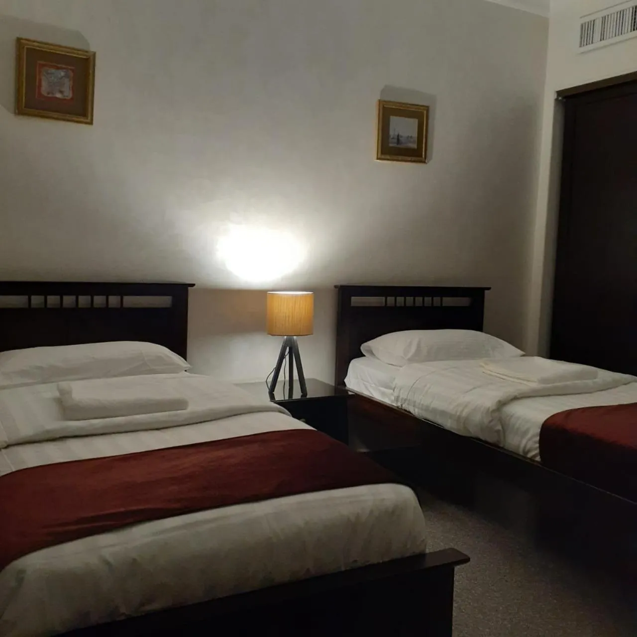 Bed in Tamrah Suites Hotel