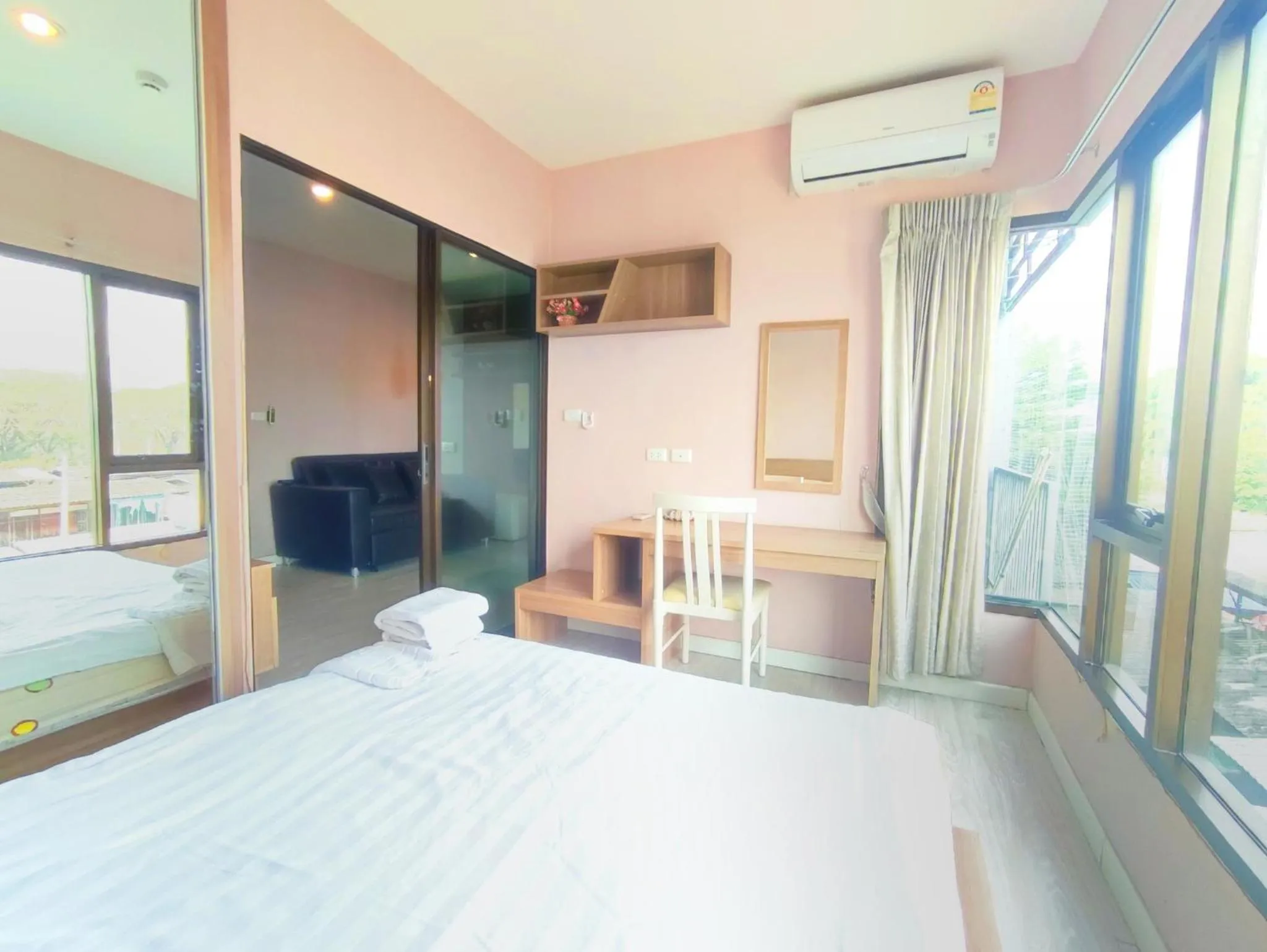 Bed in Deluxe Rooms by Suwan Style Agency