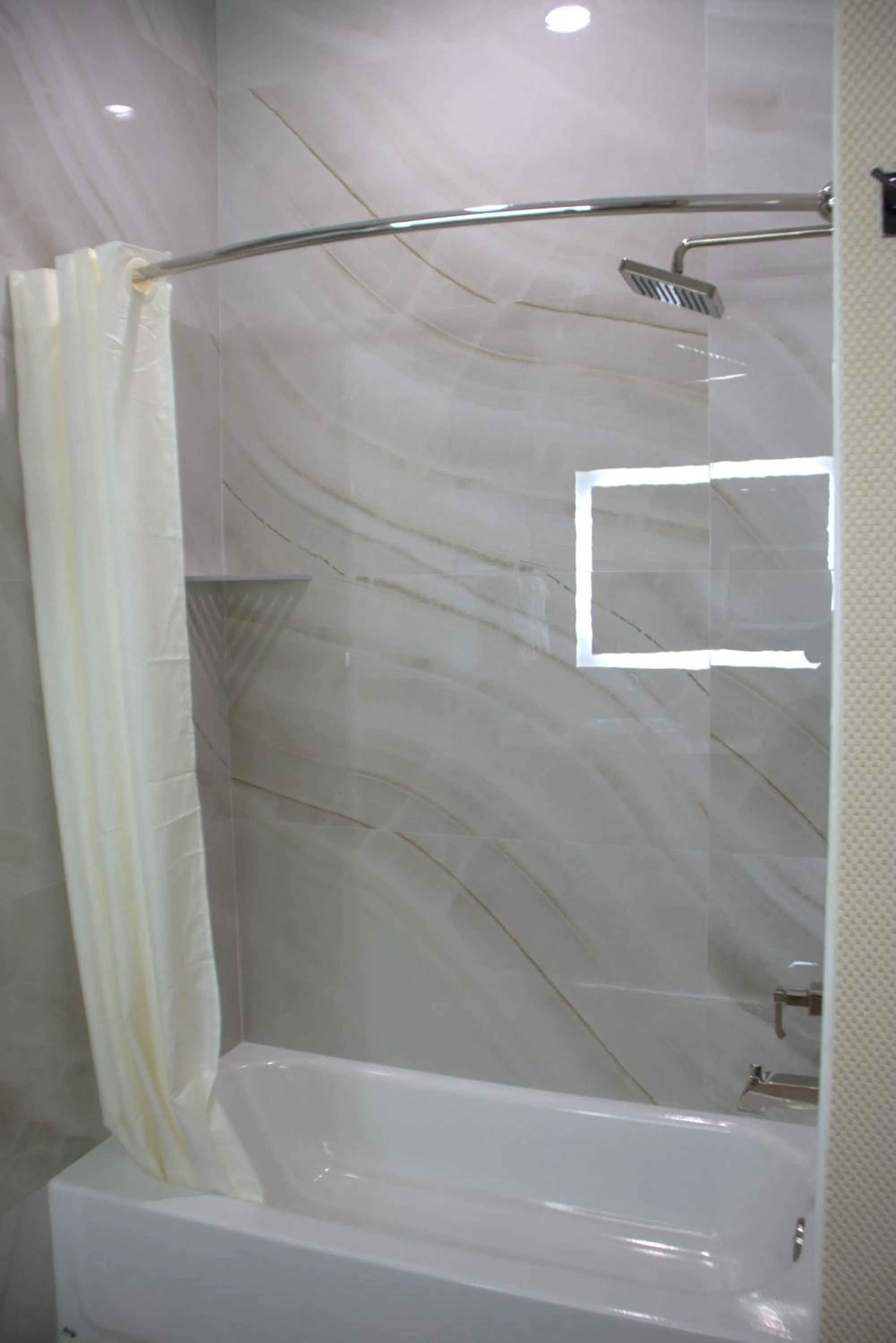 Shower in Comfeeni Inn and Suites