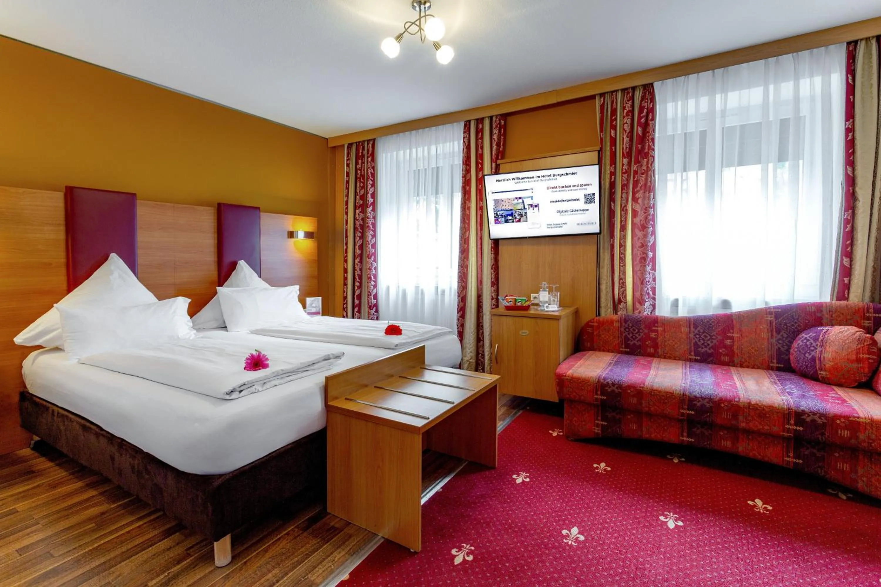 Photo of the whole room, Bed in TIPTOP Hotel Burgschmiet Garni