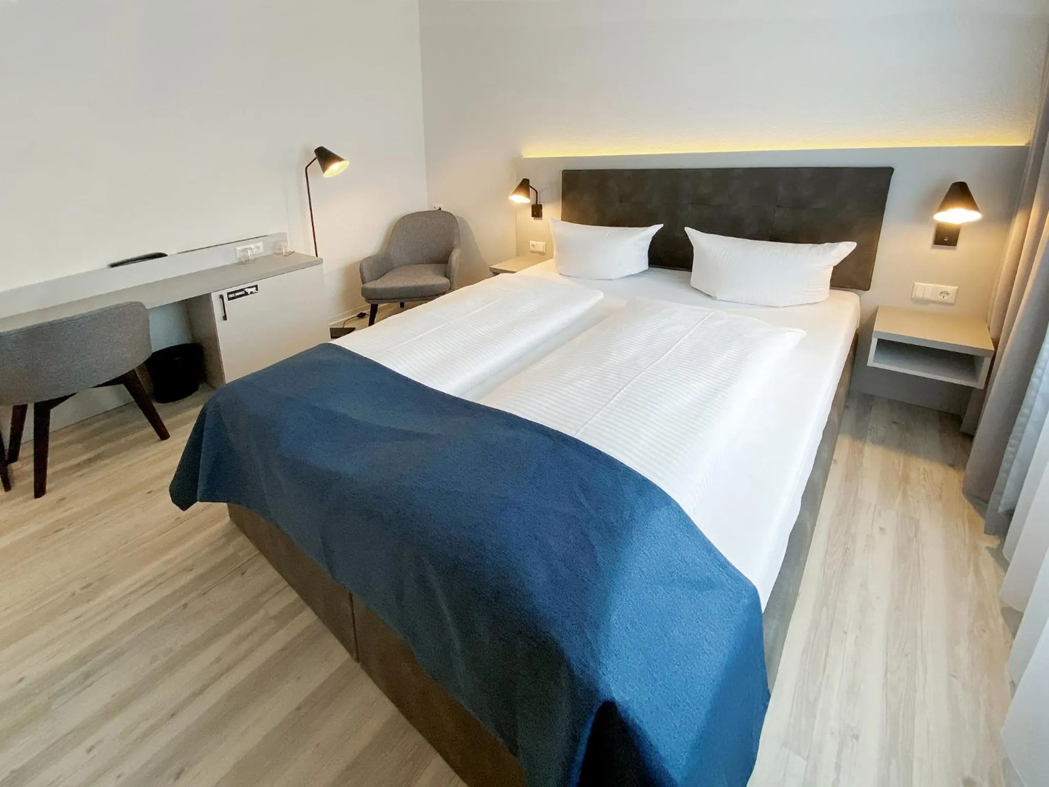 Bed in DORMERO Hotel Greifswald