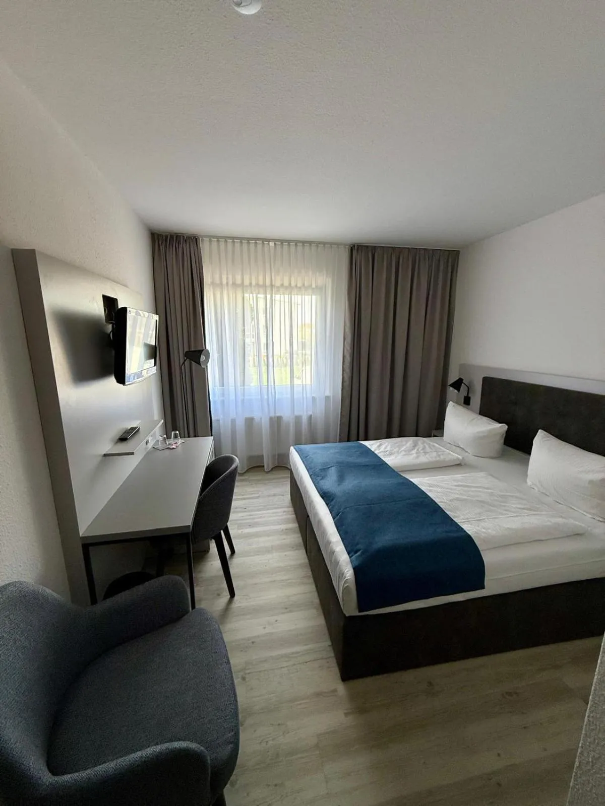 Bed in DORMERO Hotel Greifswald