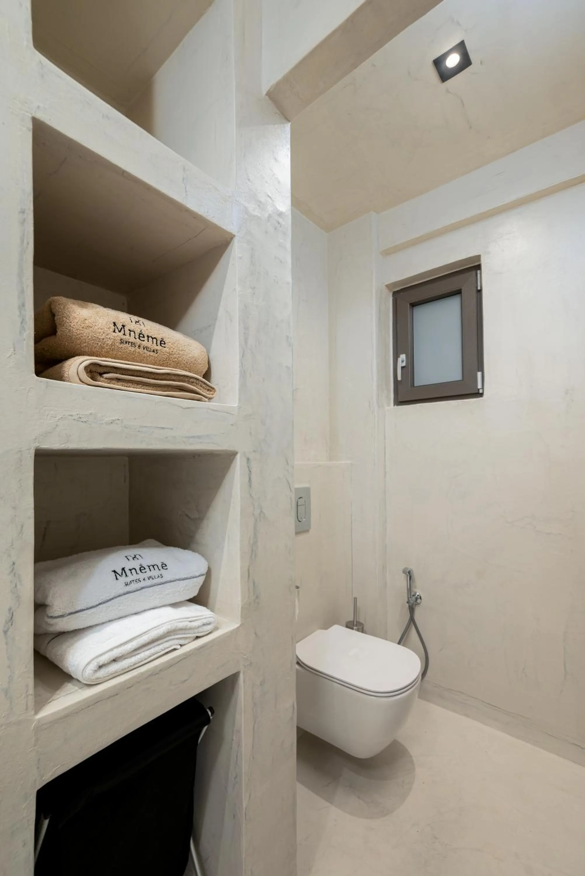 Toilet in Mnḗmē Suites & Villas