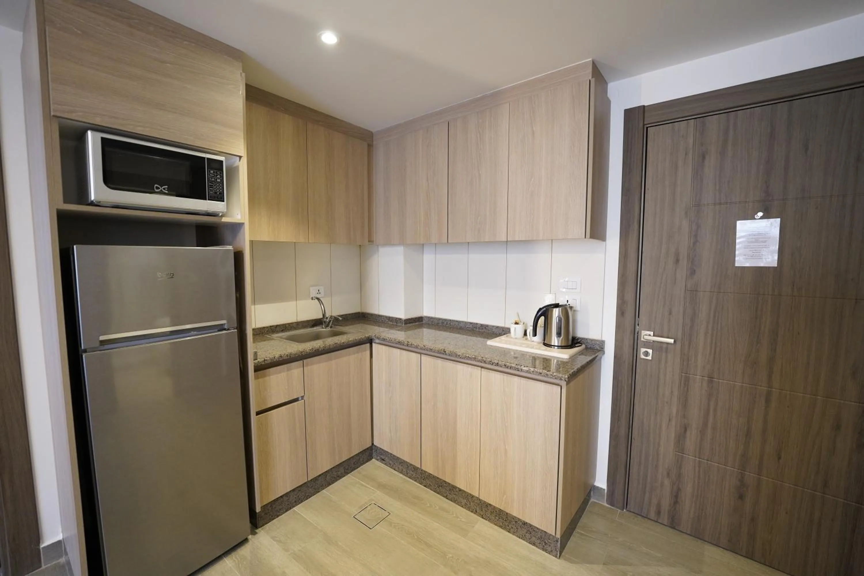 Kitchen or kitchenette in Red Carpet Hotel & Suites
