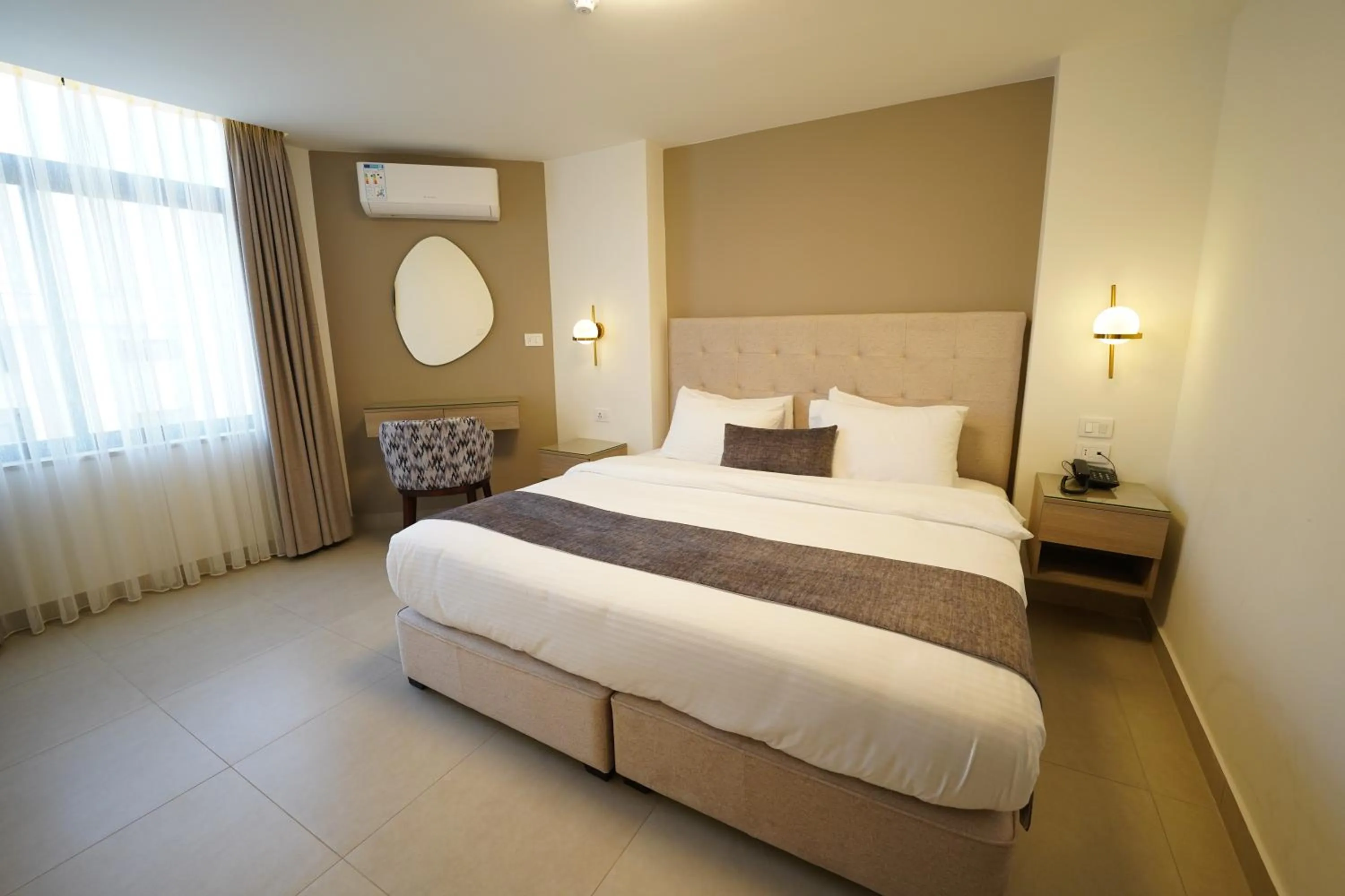 Bed in Red Carpet Hotel & Suites