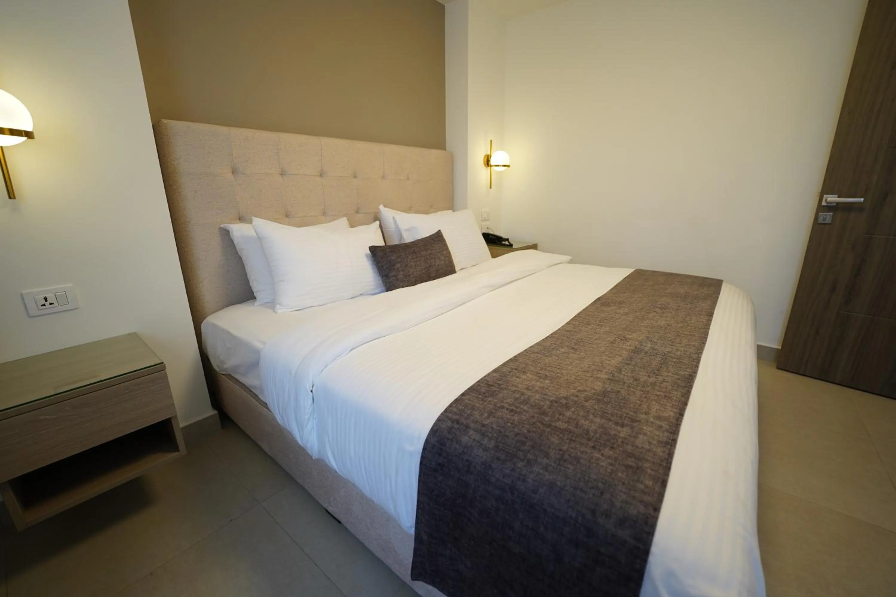 Bed in Red Carpet Hotel & Suites