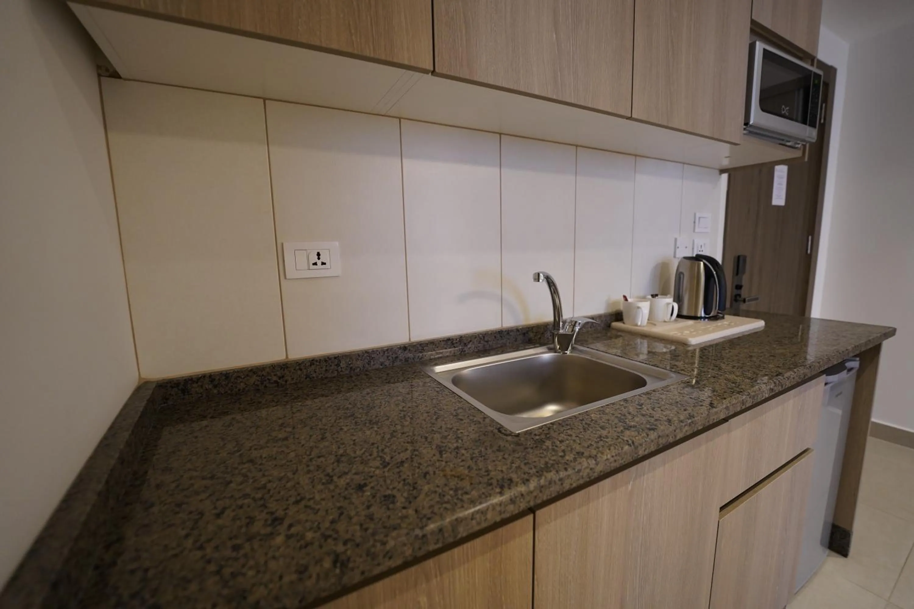 Kitchen or kitchenette in Red Carpet Hotel & Suites