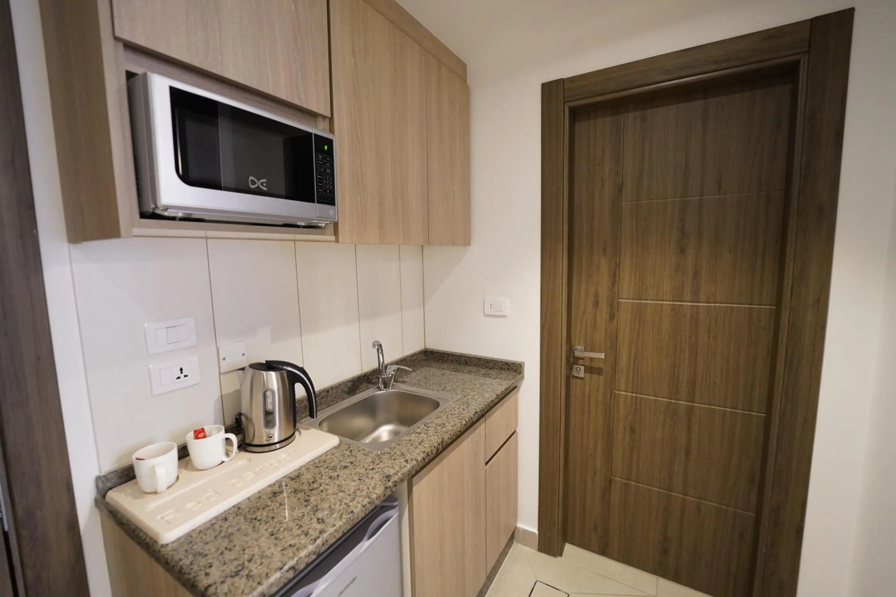 Kitchen or kitchenette in Red Carpet Hotel & Suites