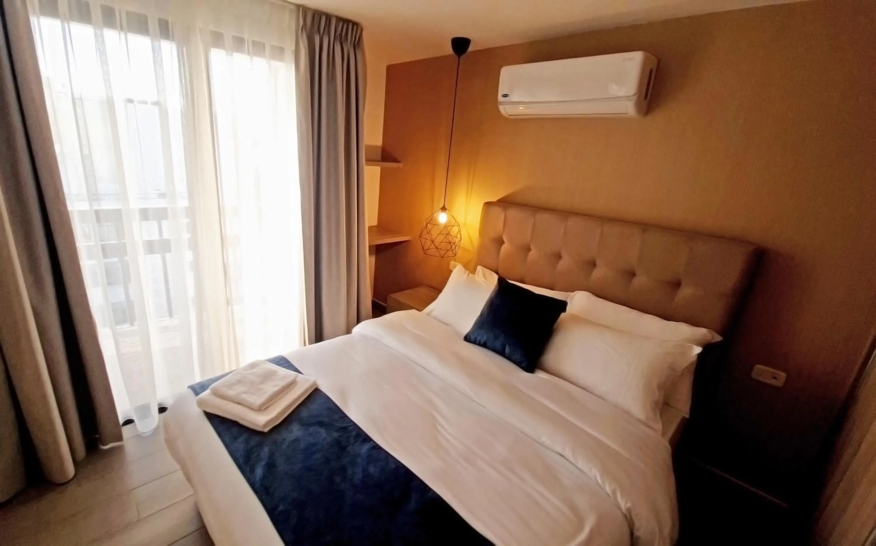 Bed in Red Carpet Hotel & Suites