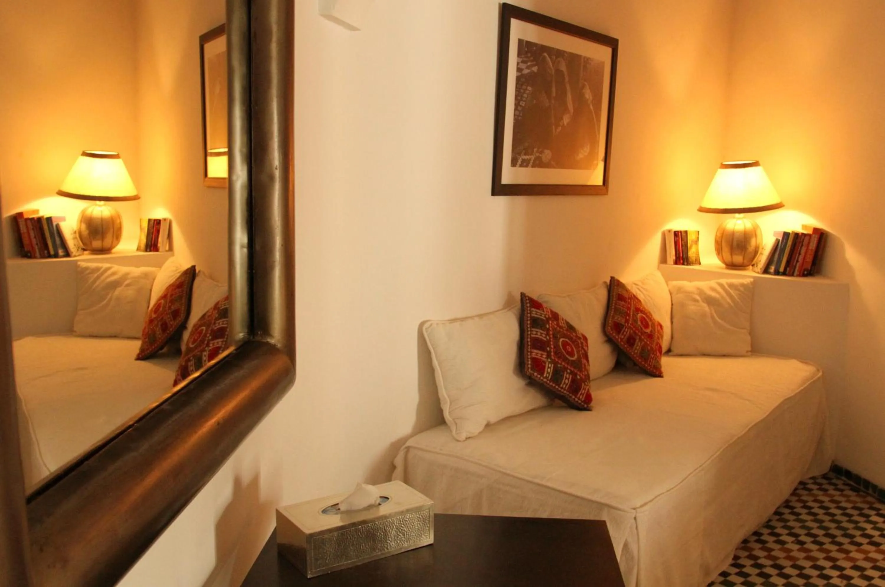 Seating area, Bed in Riad Laaroussa