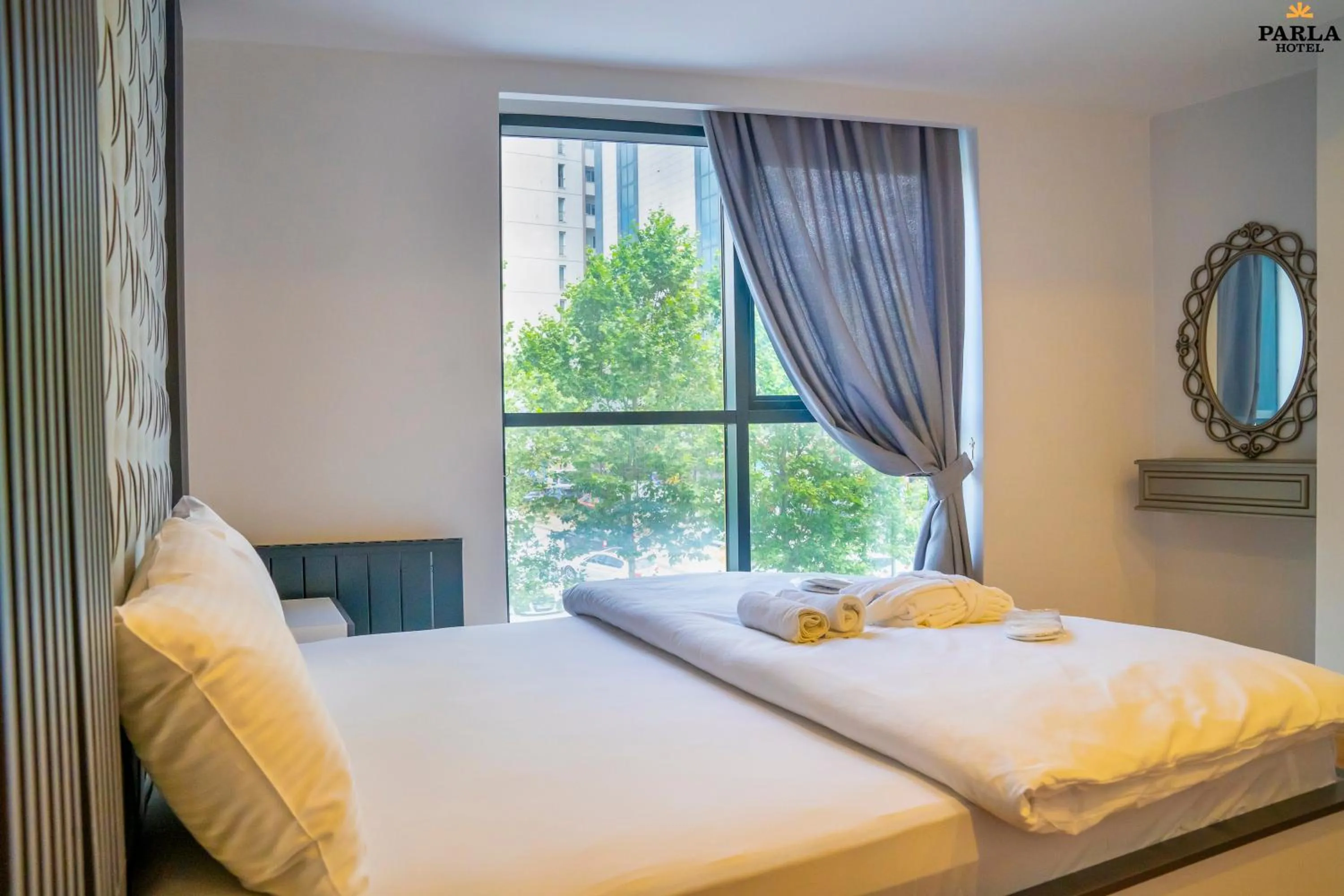 Bed in Parla Suite Hotel