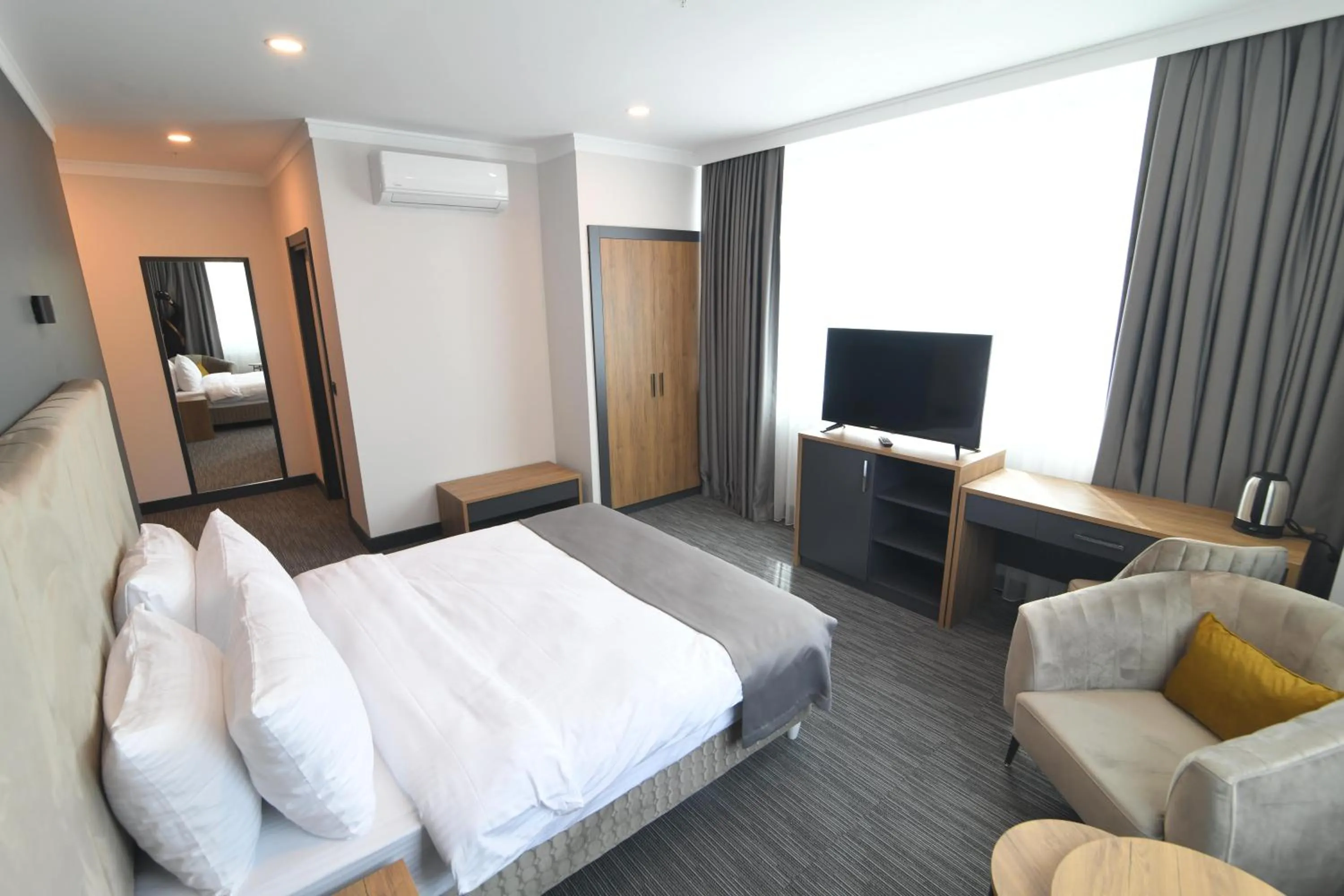 Bed in HOME PLUS Hotel