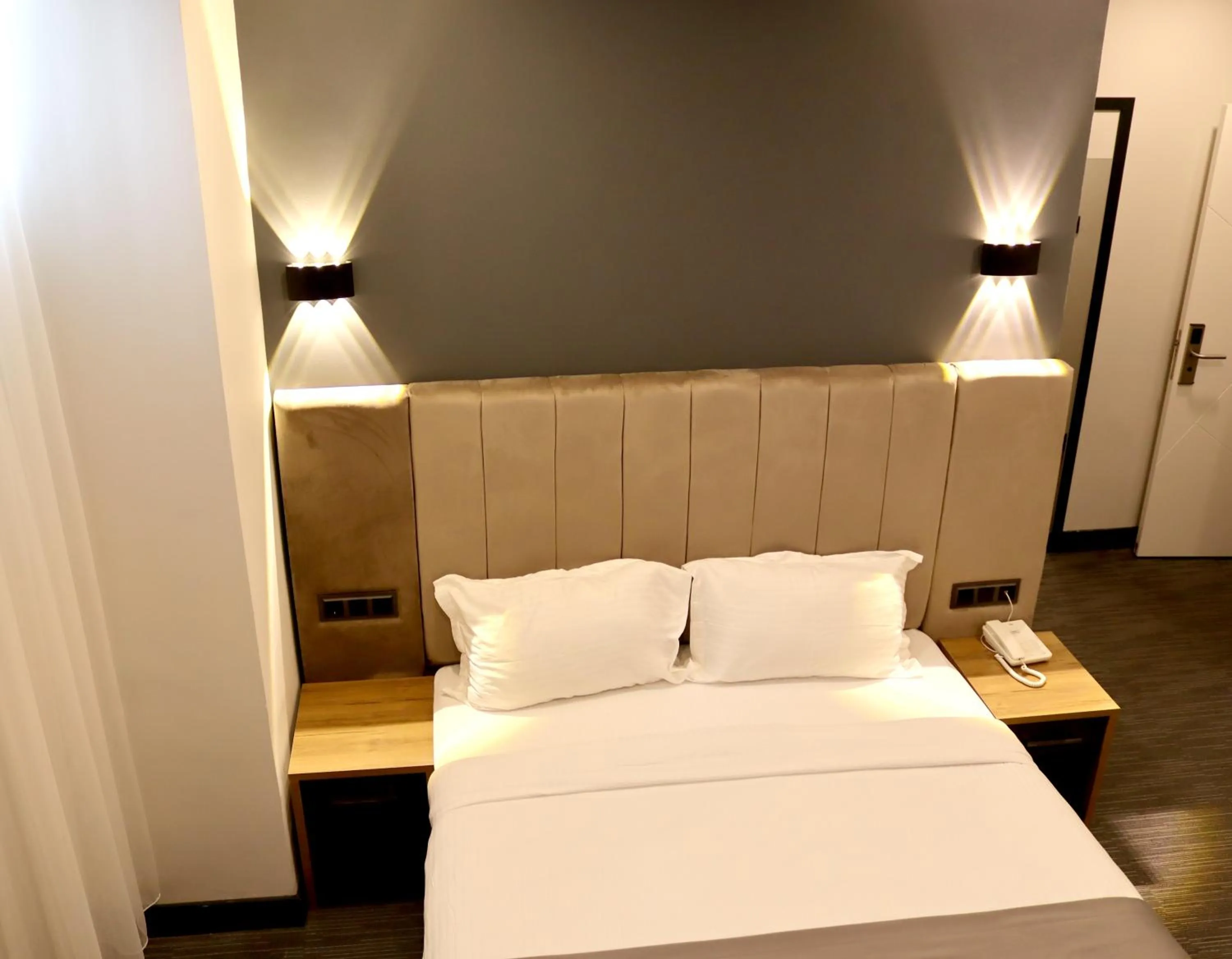 Bed in HOME PLUS Hotel