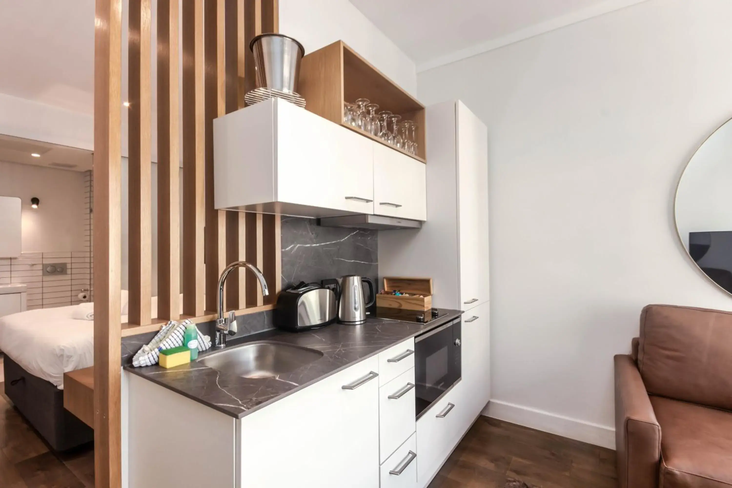 Kitchen or kitchenette, Bed in The Barracks Apartments Kitchen or kitchenette, Bed in The Barracks Apartments