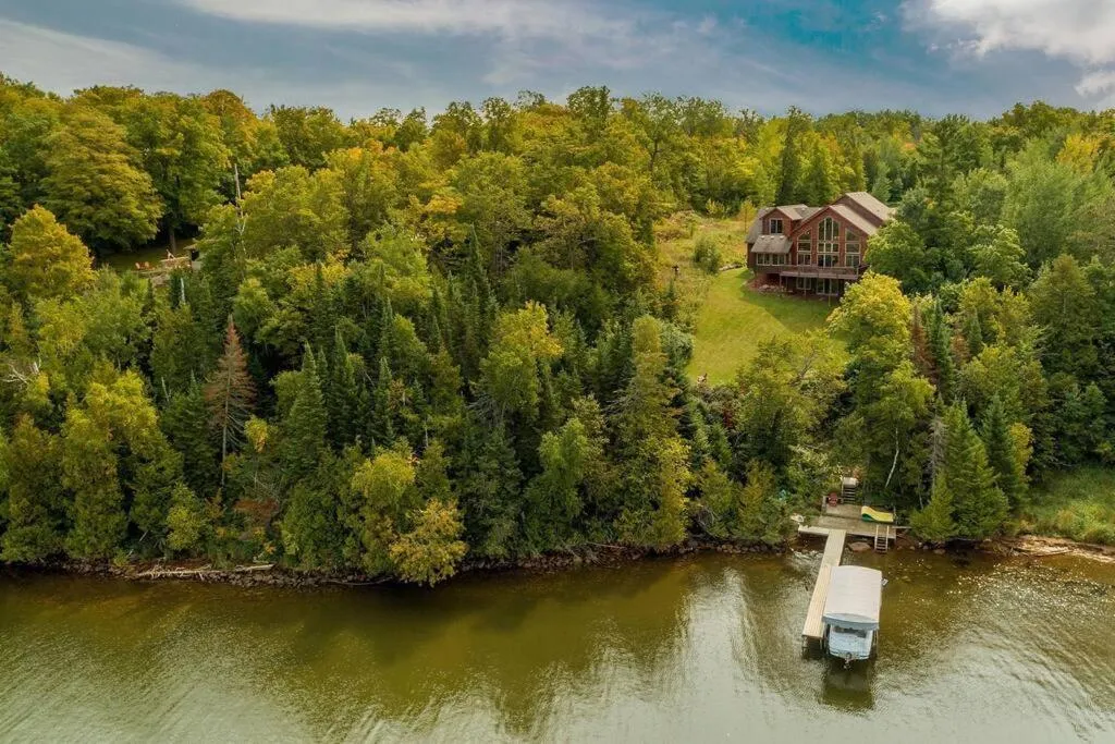 Property building in Spacious Leech Lake Home on 2 Private Acres, 200' of lake shore 15 Minutes to Walker with boat lift, dock, swimming, fire pit